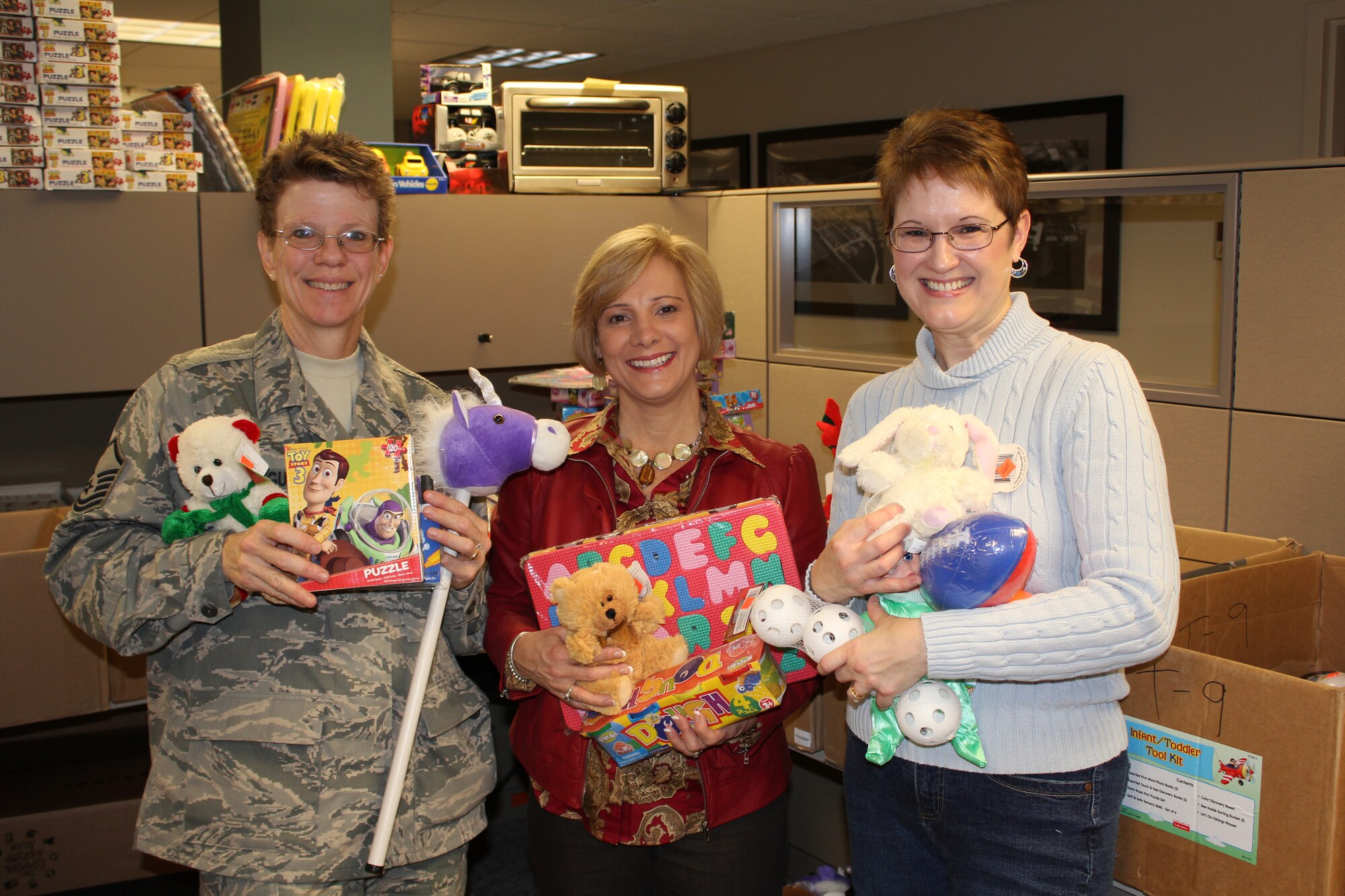 Operation Doll Homefront and Dollar Tree stores donated toys to help military families be more able to provide gifts to their children. (Left to right) Master Sgt. Deb Teague, Mrs. Faith Edwards, and Mrs. Wendy McDonnell joined together to organize hundreds of toys so families could more easily select gifts for their children. (U.S. Air Force photo/Tech. Sgt. Gerald Sonnenberg)
