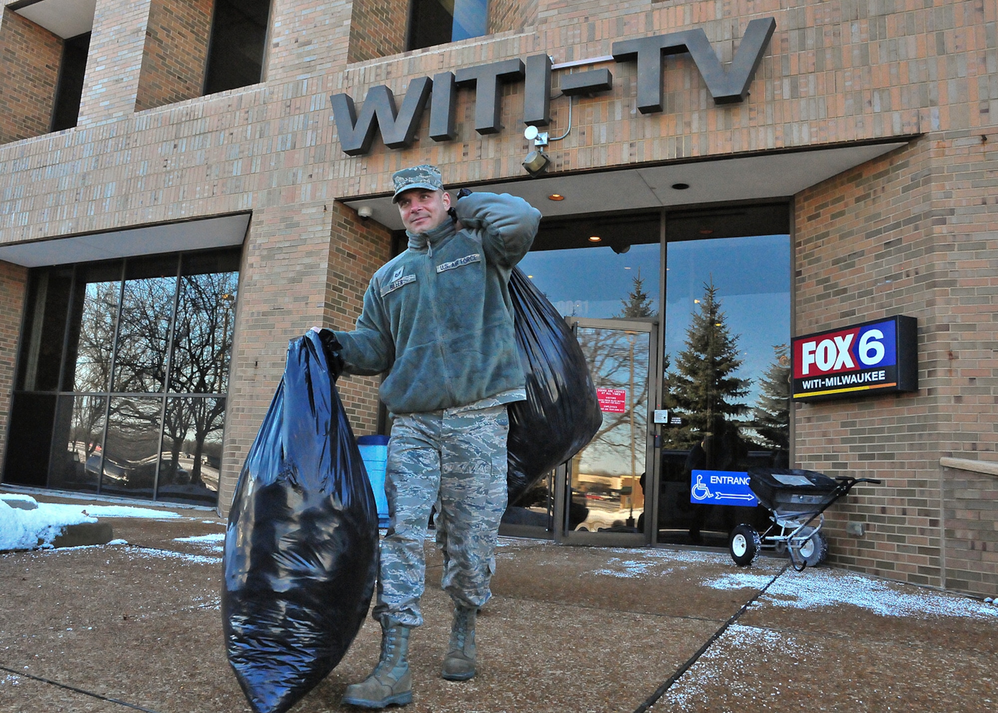 Milwaukee Air Guardsman Tech. Sgt. Chance Biller carries bags of donated winter coats from the Fox 6 Milwaukee studio to a Salvation Army van Friday, 10 Dec. 2010.

Biller had organized a winter coat collection drive at the 128th Air Refueling Wing, dubbed “OPERATION: Winter Warmth,” to coincide with Fox 6 Milwaukee Meteorologist Vince Condella’s “Coats for Kids.”

Biller estimated that the 128th Airmen donated over 100 coats during his month-long collection drive.

The coat drive is one of many charitable efforts undertaken by the Airmen of the 128th Air Refueling Wing.  Other such efforts include Habitat for Humanity, the Hunger Task Force and the annual Combined Federal Campaign (CFC).