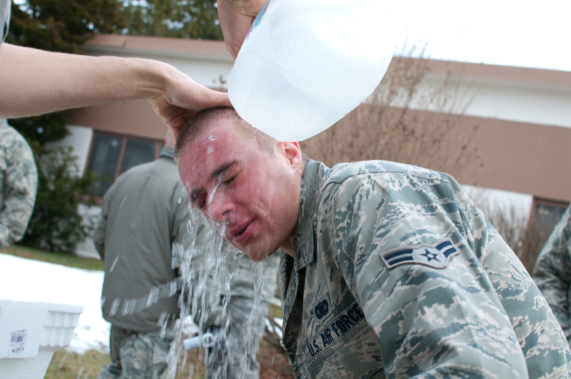 Airman 1st Class Weise of the 102nd Security Forces Suadron tries to find relief after being sprayed with pepper-spray as part of a security forces training event held on Otis Air National Guard Base, Mass. on January 9, 2011. Security Forces airmen were sprayed with the pepper-spray so they are familiar with it's affects and can still perform their duties if they come in contact with it. 