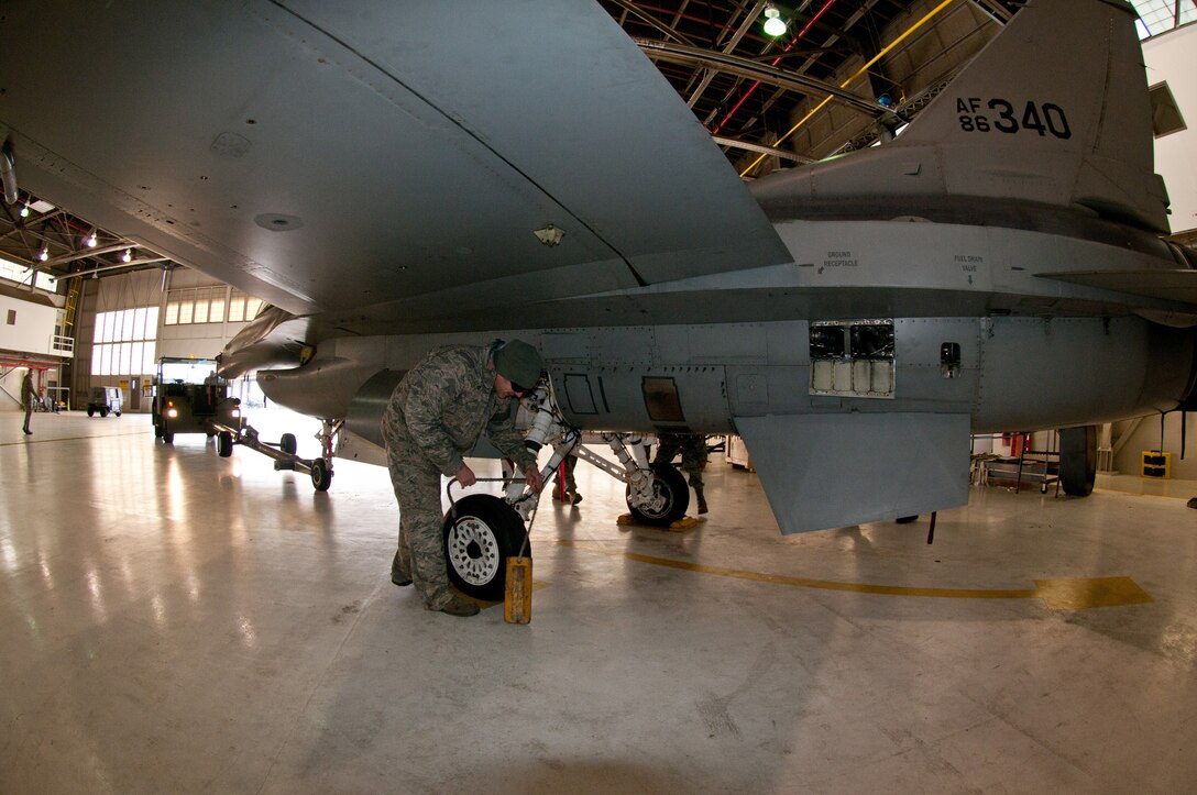 Master Sgt Mark Dailey, 113th Wing Maintenance Group, District of Columbia Air National Guard, chalks the tire of an F-16 that is being brought in for its 300 hour phase inspection Jan. 8, 2011 at Joint Base Andrews, Md. (U.S. Air Force photo by Master Sgt. Dennis Young)