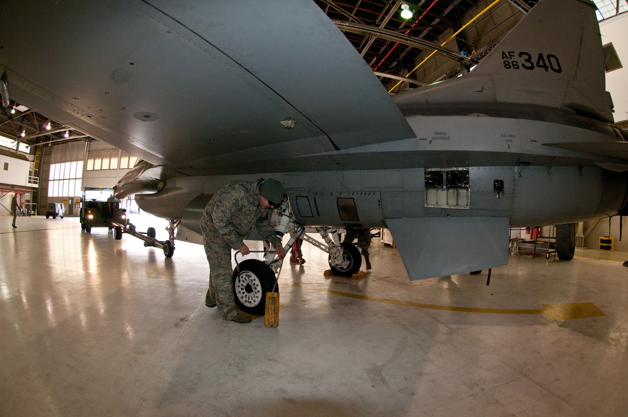 Master Sgt Mark Dailey, 113th Wing Maintenance Group, District of Columbia Air National Guard, chalks the tire of an F-16 that is being brought in for its 300 hour phase inspection Jan. 8, 2011 at Joint Base Andrews, Md. (U.S. Air Force photo by Master Sgt. Dennis Young)