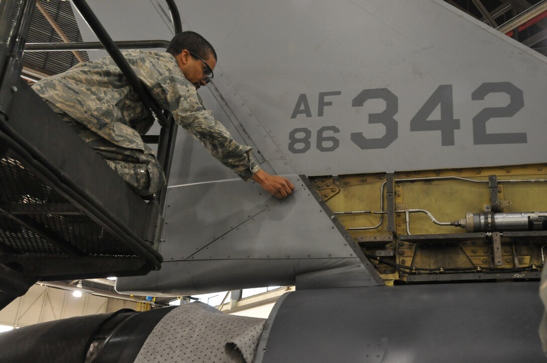 Staff. Sgt Ebon Mitchell,113th Wing maintenance group, District of Columbia Air National Guard, replaces F-16 body panels after a 300 hour phase inspection Jan. 7, 2011 at Joint Base Andrews, Md. (U.S. Air Force photo by Tech. Sgt William R. Parks)