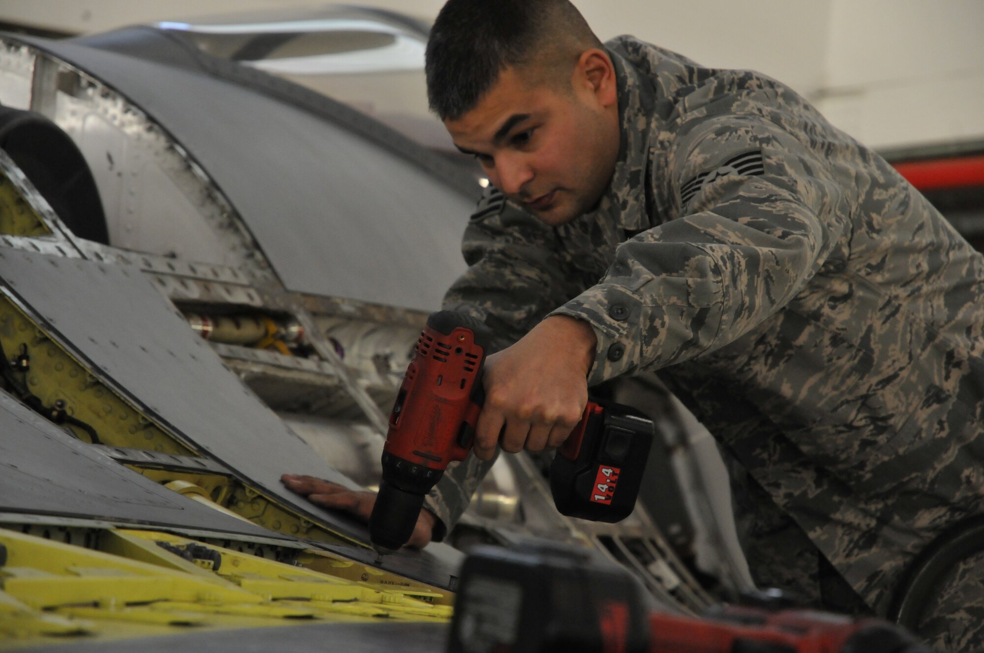 Staff Sgt. William Johnson,113th  Wing Maintenance Group, District of Columbia Air National Guard, attaches a panel during part of the phase inspection Jan.  7, 2011 at Joint Base Andrews, Md. (U.S. Air Force photo by Tech. Sgt William R. Parks)