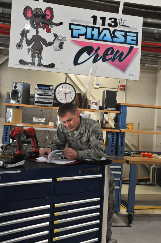 Tech. Sgt John M. Spurr,113th Wing Maintenance Group, District of Columbia Air National Guard, references a technical order for signing off Aircraft phase requirements Jan. 7, 2011 at Joint Base Andrews (U.S. Air Force photo by Tech. Sgt William R. Parks)