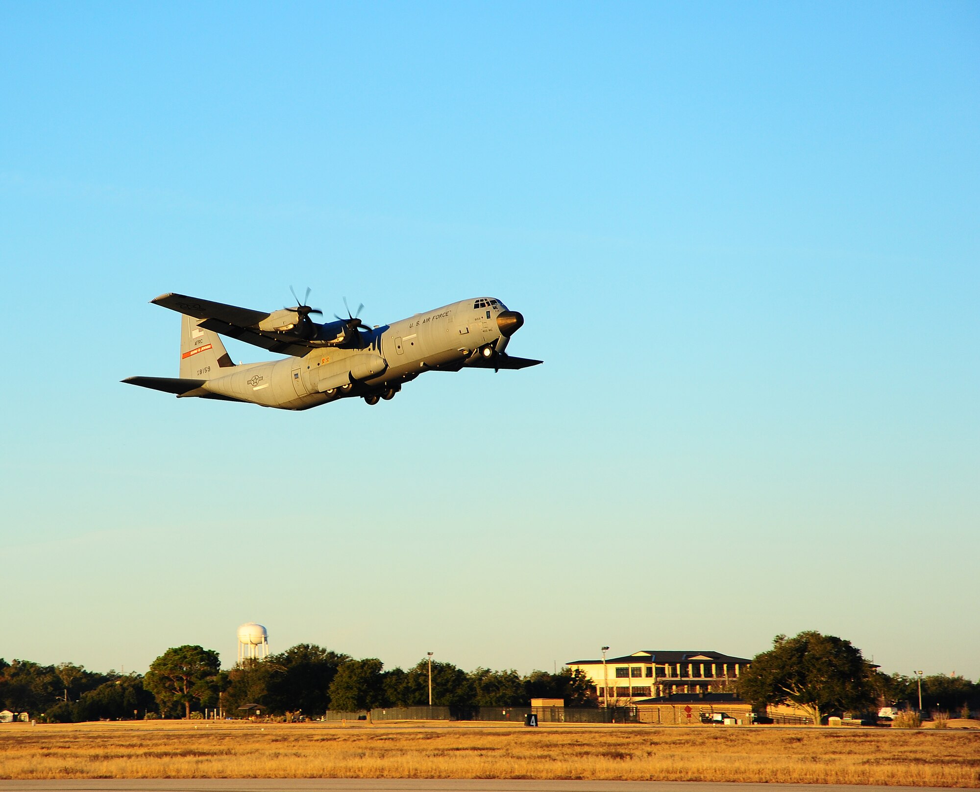 A C-130J-30 carrying members from the 403 MXG, 815th and 345th AS takes off.   Reservists with the 403rd MXG and 815th AS and active-duty members from the 345th AS deployed for 120 days in support of overseas contingency operations in Southwest Asia. The 815th "Flying Jennies" and 345th "Golden Eagles," an active associate unit, work and train side by side as part of the 403rd Wing at Keesler AFB, Miss.  (U.S. Air Force photo by Staff Sgt. Yolanda Addison)
