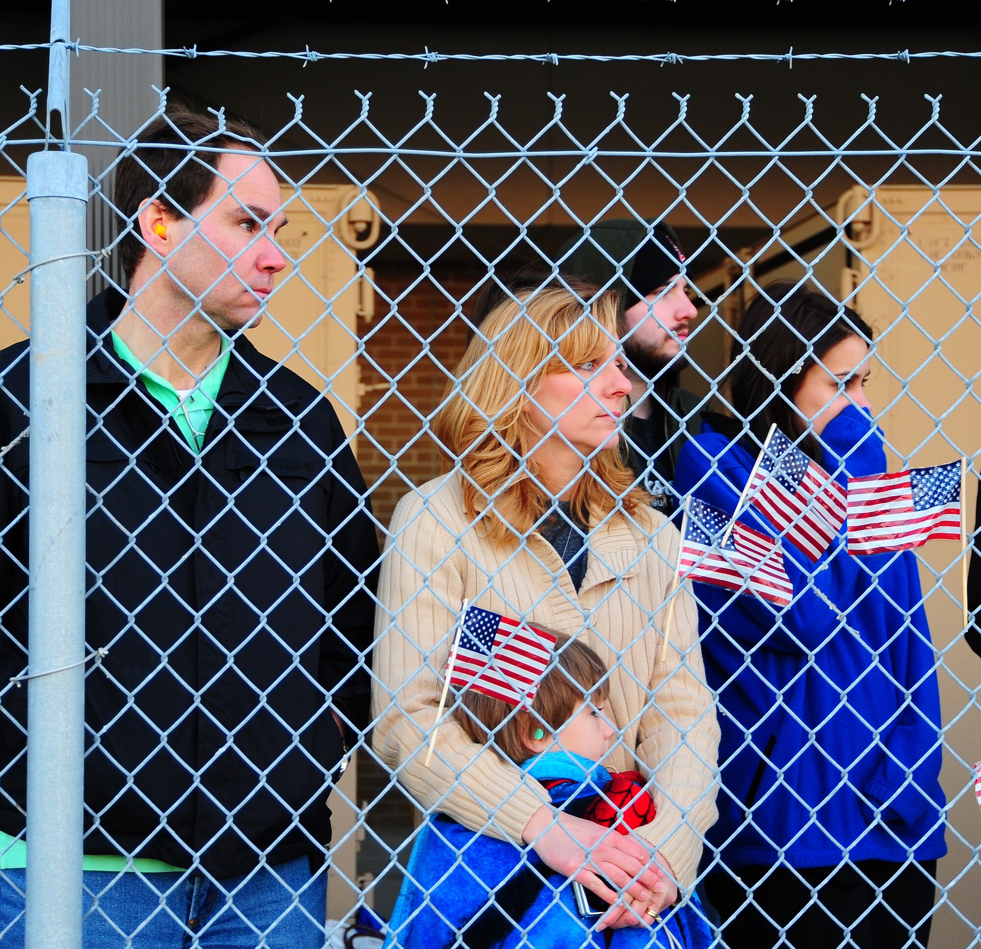Peri and Jordan Keely, wife and son of Master Sgt. Brett Keely, 403rd AMXS, along with his brother Garth, patiently await the deployers departure.   Reservists with the 403rd MXG and 815th AS and active-duty members from the 345th AS deployed for 120 days in support of overseas contingency operations in Southwest Asia. The 815th "Flying Jennies" and 345th "Golden Eagles," an active associate unit, work and train side-by-side as part of the 403rd Wing at Keesler AFB, Miss.  (U.S. Air Force photo by Staff Sgt. Yolanda Addison)

