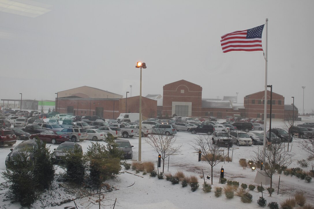 The flag dedicated to Tech. Sgt. Anthony Campbell, Jr., during a Dec. 11 ceremony waves proudly during the area's first snow fall on Dec. 12. (U.S. Air Force photo/Tech. Sgt. Gerald Sonnenberg)