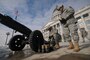 Staff Sgt. Brian Koka and Sgt. 1st Class Brent Portwood of the Utah National Guard begin to clean up their artillery piece after firing a 19-gun salute at the inauguration of Utah Gov. Gary R. Herbert on Jan. 3, 2011, at the State Capitol building in Salt Lake City.(U.S. Air Force photo by Master Sgt. Gary J. Rihn)(RELEASED) 