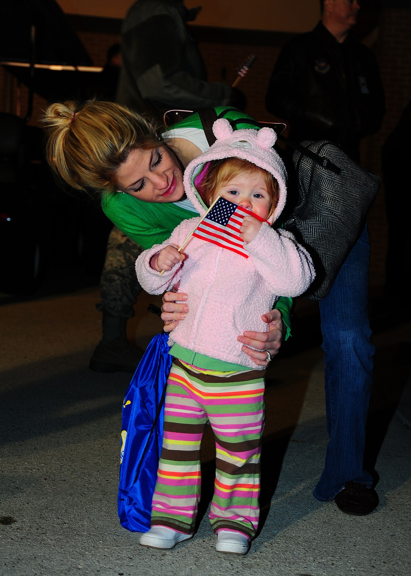 Jamie Black, sister of Senior Airman Addison Black, 403rd MXS, holds back Grace Hernandez, Senior Airman Black’s niece, as she tries to walk on the flightline toward the C-130J-30. Reservists with the 403rd Maintenance Group and 815th AS and active-duty members from the 345th AS deployed for 120 days in support of overseas contingency operations in Southwest Asia. The 815th "Flying Jennies" and 345th "Golden Eagles," an active associate unit, work and train side-by-side as part of the 403rd Wing at Keesler Air Force Base, Miss.  (U.S. Air Force photo by Staff Sgt. Yolanda Addison)
