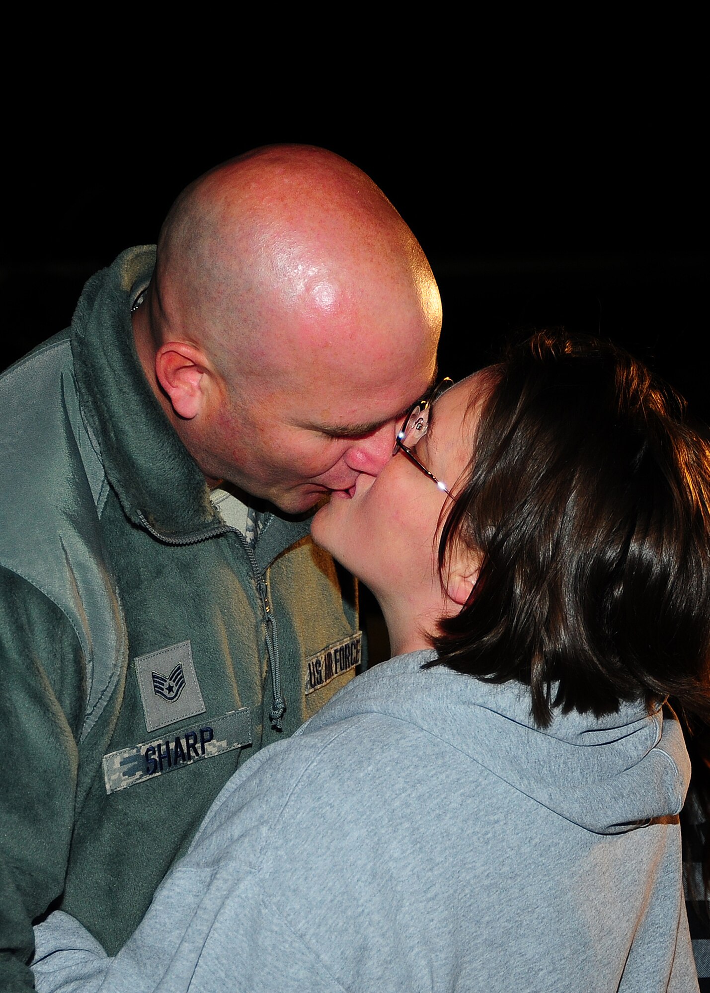 Staff Sgt. Jason Sharp, 403rd Aircraft Maintenance Squadron, and his wife Jennifer, kiss just before he gets on the C-130J-30 Jan. 8. Reservists with the 403rd Maintenance Group and 815th AS and active-duty members from the 345th AS deployed for 120 days in support of overseas contingency operations in Southwest Asia. The 815th "Flying Jennies" and 345th "Golden Eagles," an active associate unit, work and train side-by-side as part of the 403rd Wing at Keesler Air Force Base, Miss.  (U.S. Air Force photo by Staff Sgt. Yolanda Addison)
