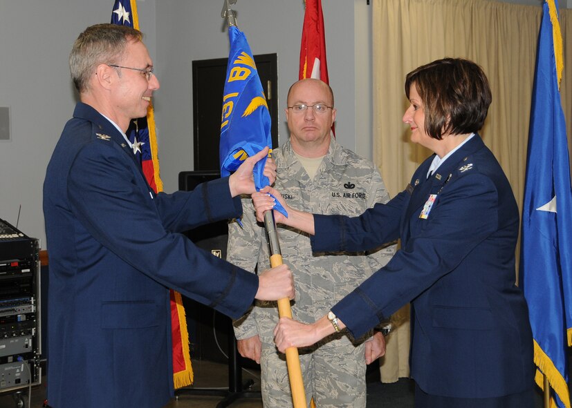 Col Kathleen Hancox receives the Mission Support Group guidon from Col Greg Champagne, 131st Bomb Wing Commander, during the change of command ceremony at Lambert ANGB, Jan 8.  Hancox assumes command from Lt Col. Tim Jones, who becomes the Director of Staff at Missouri State Headquarters, Jefferson City.  (Photo by Master Sgt. Mary-Dale Amison)