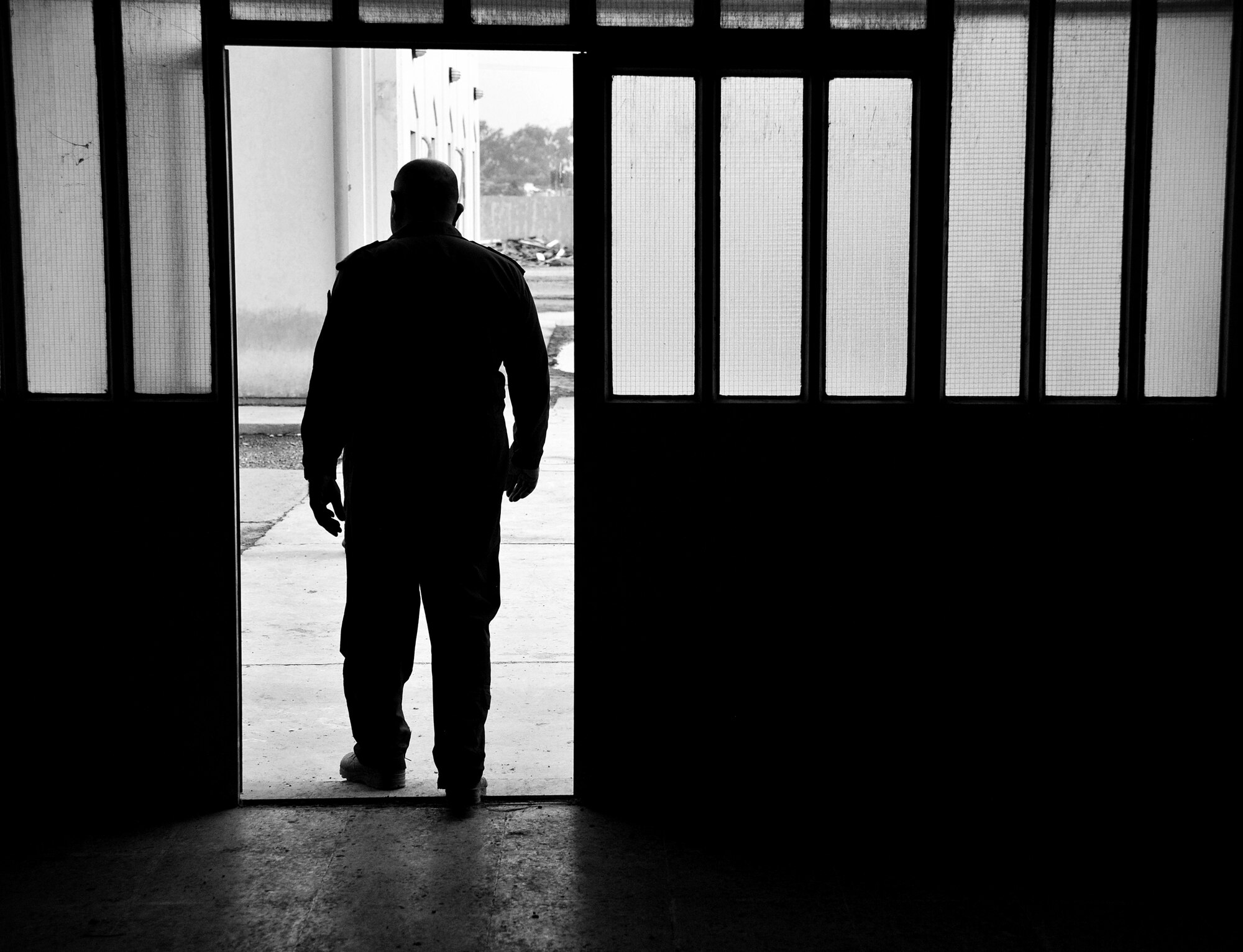 The Iraqi Air Force Training School’s commandant walks outside after a meeting with air advisors from the 821st Expeditionary Training Squadron Dec. 13, 2010, in Taji, Iraq. The 821st ETRS works daily with the faculty and students at the school to help it become an enduring and self sufficient training pipeline for the Iraqi Air Force and Ministry of Defense. (U.S. Air Force photo by Senior Airman Andrew Lee)