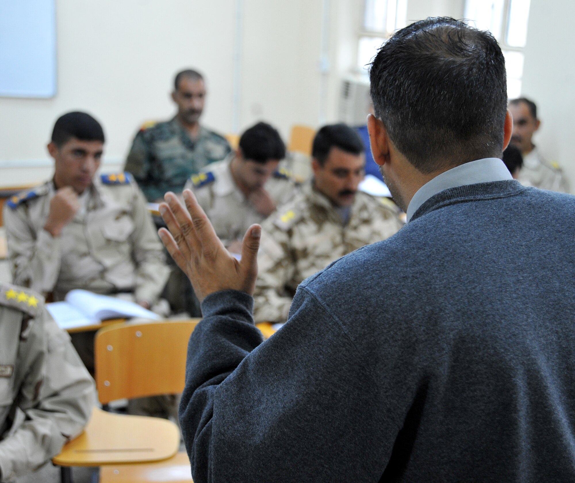 Joe Montalvo, an instructor at the Iraqi Air Force Training School, teaches a basic English Language course to a class-full of Iraqi Airmen Dec. 13, 2010, in Taji, Iraq. The 821st Expeditionary Training Squadron works daily with the faculty and students at the school to help it become an enduring and self sufficient training pipeline for the Iraqi Air Force and Ministry of Defense. (U.S. Air Force photo by Senior Airman Andrew Lee)