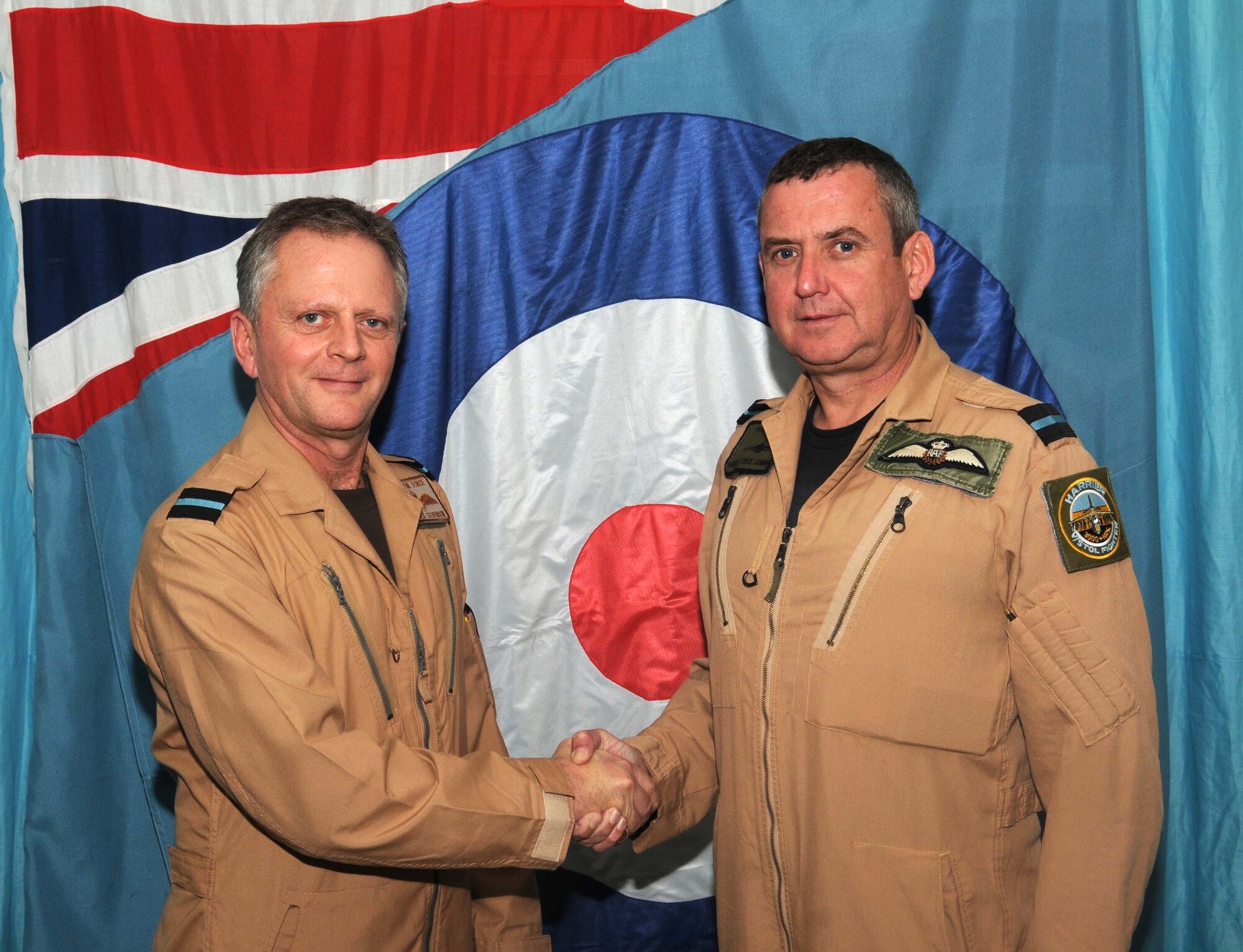 Royal Air Force Air Commander Ashley Stevenson accepts command of the 83rd Expeditionary Air Group from Air Commander Kenneth McCann inside their headquarters building in southwest Asia during a change of command ceremony Jan.6.