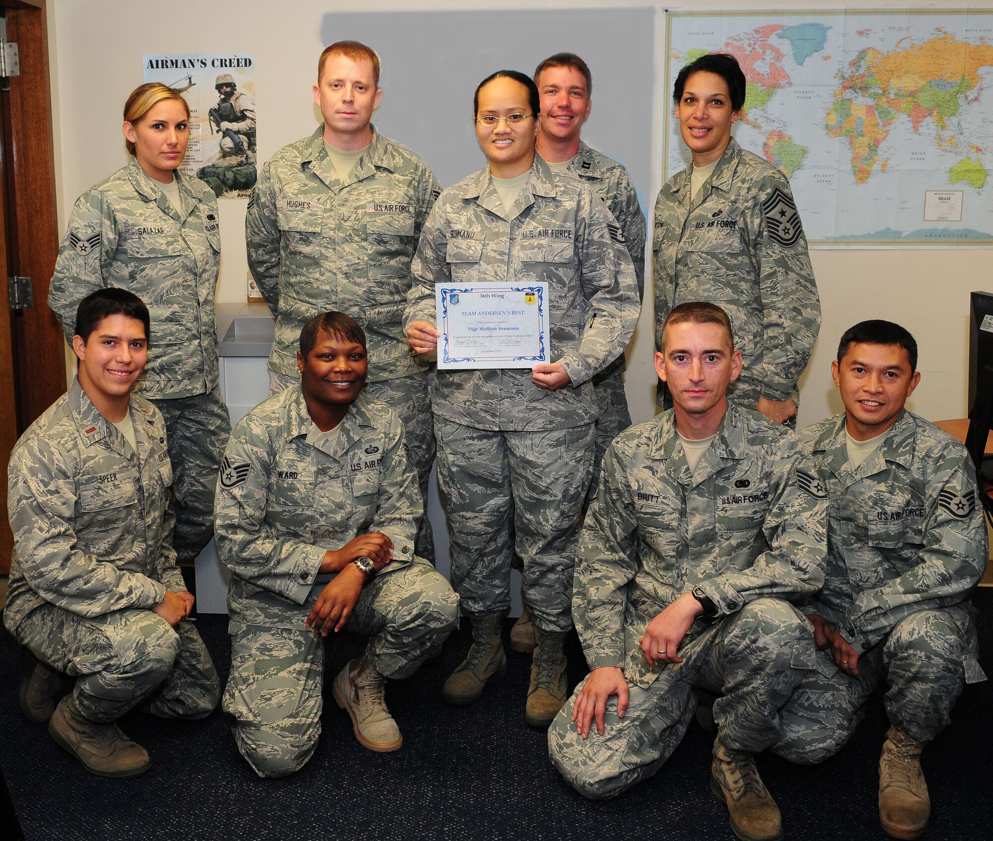 Staff Sgt. Mellissa Seumanu (center) stands with her peers after being awarded Andersen's Best here Dec. 16. As 36th Logistics Readiness Squadron deployment manager, Sergeant Seumanu ensures the 36th Wing quickly fills all Air Expeditionary Force taskings providing Pacific Air Power from Andersen Air Force Base. Andersen's Best is a recognition program which highlights a top performer from the 36th Wing. (Photo illustration/Senior Airman Nichelle Anderson)
