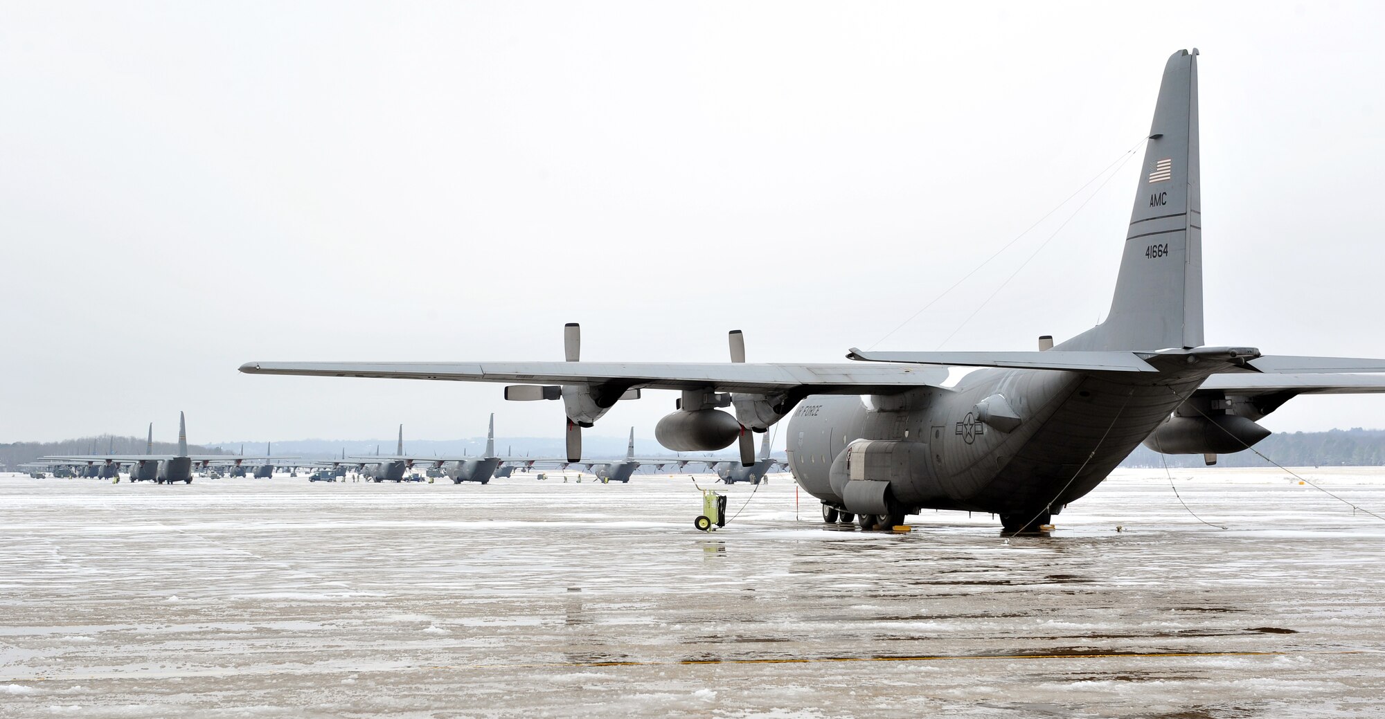 A C-130 Hercules stands covered with snow and ice among other C-130s on the flightline Jan. 10, 2011, at Little Rock Air Force Base, Ark. (U.S. Air Force photo by Staff Sgt. Chris Willis)