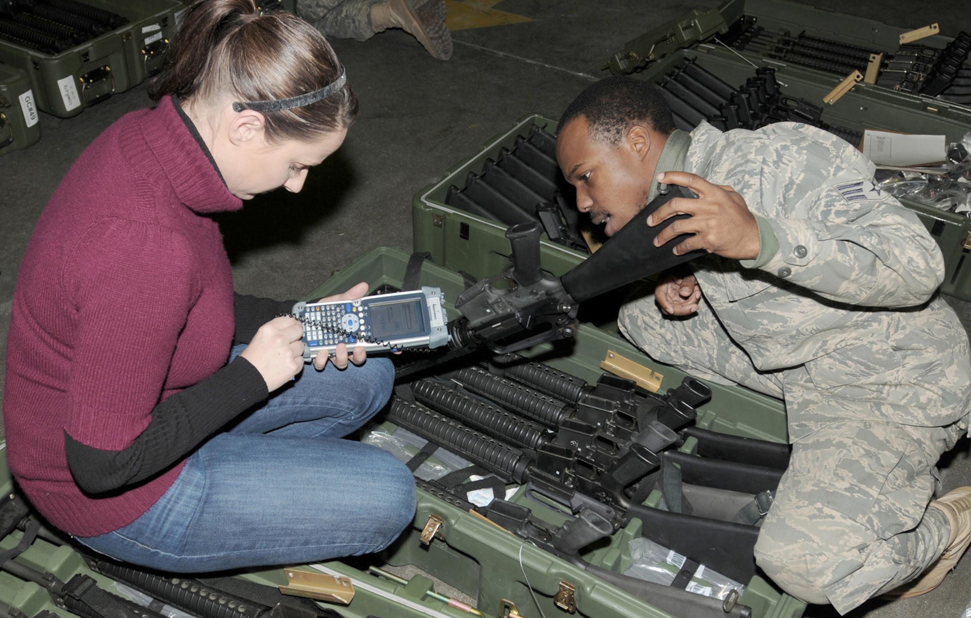 Lorae Gudgel and Senior Airman Rashon Forbes scan a barcode on a weapon for inventory Dec. 17, 2010, as part of the new asset marking and tracking system being implemented at Air Force installations around the world. Each piece of equipment is being marked with a unique bar code that, when scanned, will provide the serial number and equipment information, including what the piece of equipment is, to which base it belongs and to whom it has been issued. Ms. Gudgel is a marking technician with A2B Company. Airman Forbes is a document control technician with the 31st Logistics Readiness Squadron. (U.S. Air Force photo/Tech. Sgt. Darrell Dean)