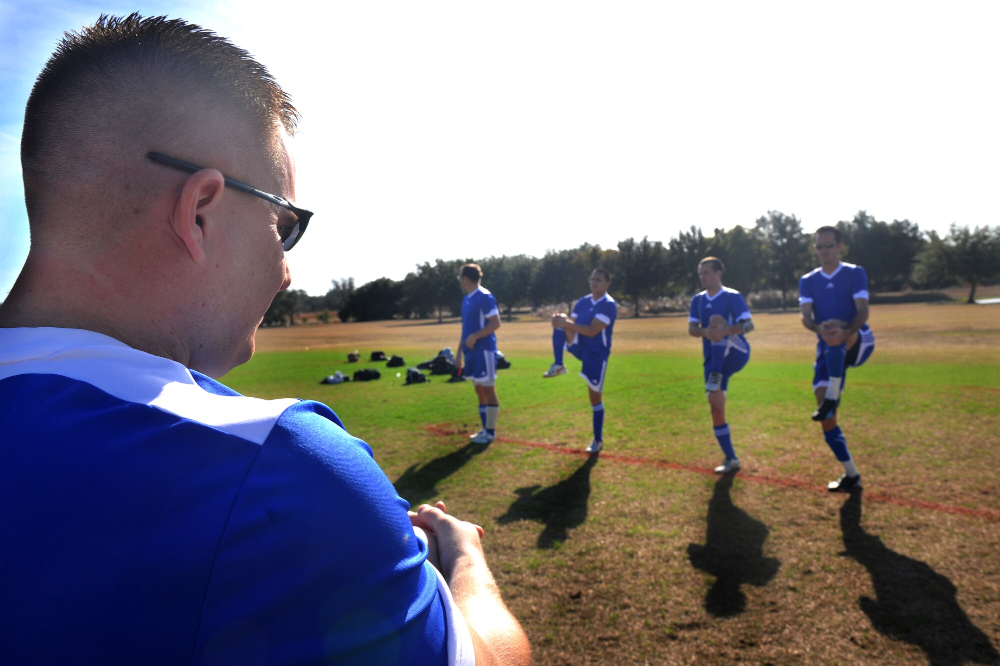 KISSIMMEE, Fl.-- Timothy Fry, coach for the Moody Air Force Base, Ga. soccer team, has team members stretch before the first game at the Blizzard Blast tournament in Kissimmee, Fl, Jan. 8. The team traveled from Moody to Kissimmee for the two day tournament where they placed fourth overall. (U.S. Air Force photo/Airman 1st Class Joshua Green)(RELEASED)
