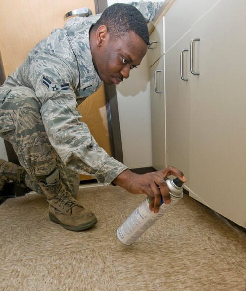 Airman 1st Class Thomas Davis, 2nd Civil Engineer Squadron pest management section, sprays 565 Plus XLO, a contact insecticide, in a dormitory on Barksdale Air Force Base, La., Jan. 10. The pest management section is responsible for preventing and controlling insect and rodent populations in base facilities as well as neutralizing the threat of potentially dangerous animals on base. (U.S. Air Force photo/Senior Airman Chad Warren)(RELEASED)