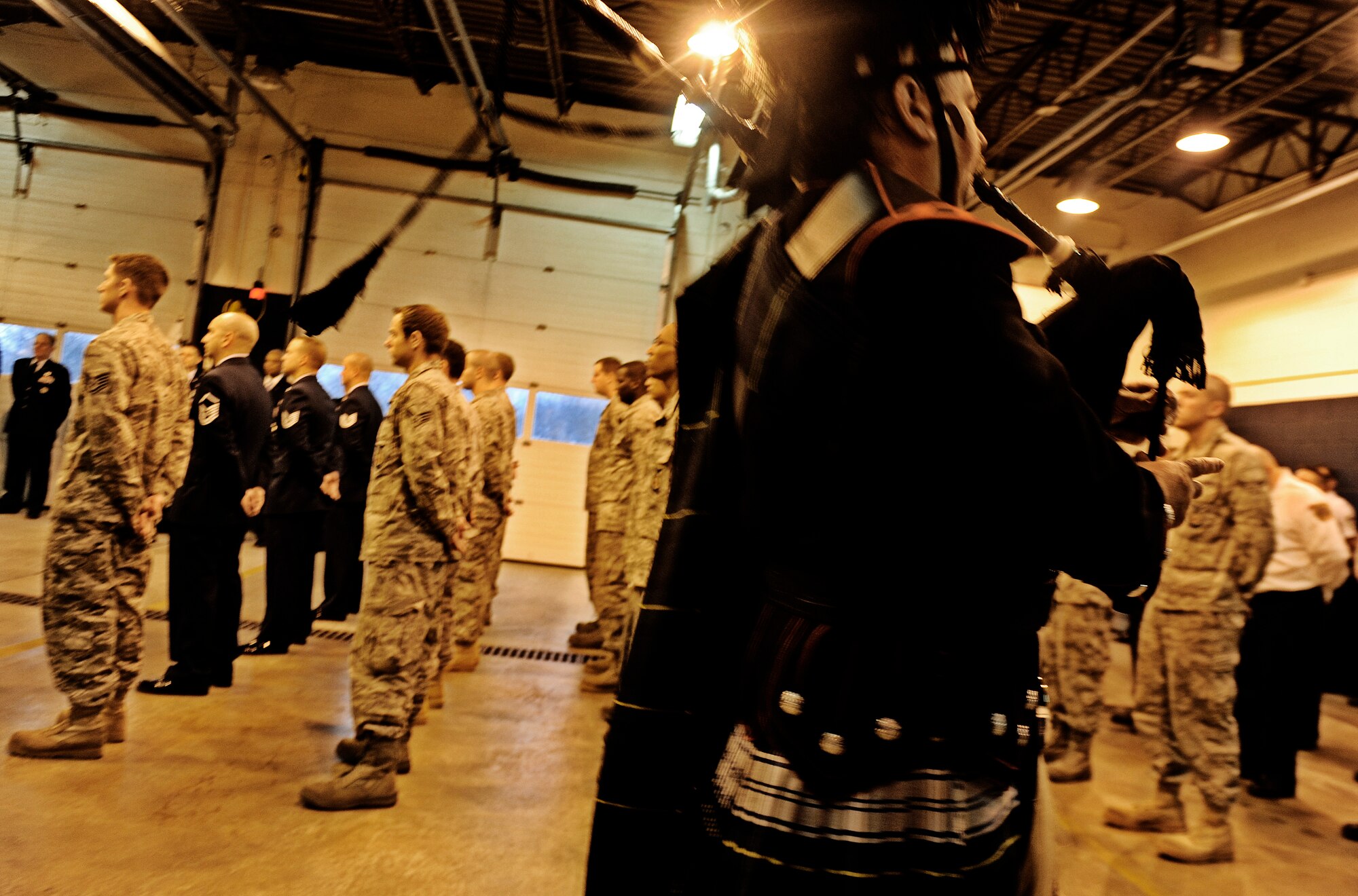 Mike Edwards, retired assistant fire chief, plays the ceremonial bagpipe during a Final Alarm Ceremony in honor of Rick Grammer, Air Mobility Command fire chief, Jan. 10, 2010 at Scott Air Force Base, Ill.  Mr. Grammer passed away last week. A Final Alarm Ceremony is a traditional final tribute to a firefighter who has passed.  The ceremony begins by calling the passed firefighter’s name and is followed by the ringing of the ceremonial fire bell.  Bagpipes are also commonly played.  The ceremony represents the firefighter’s final call to duty. (U.S. Air Force photo/ Staff Sgt. Ryan Crane)