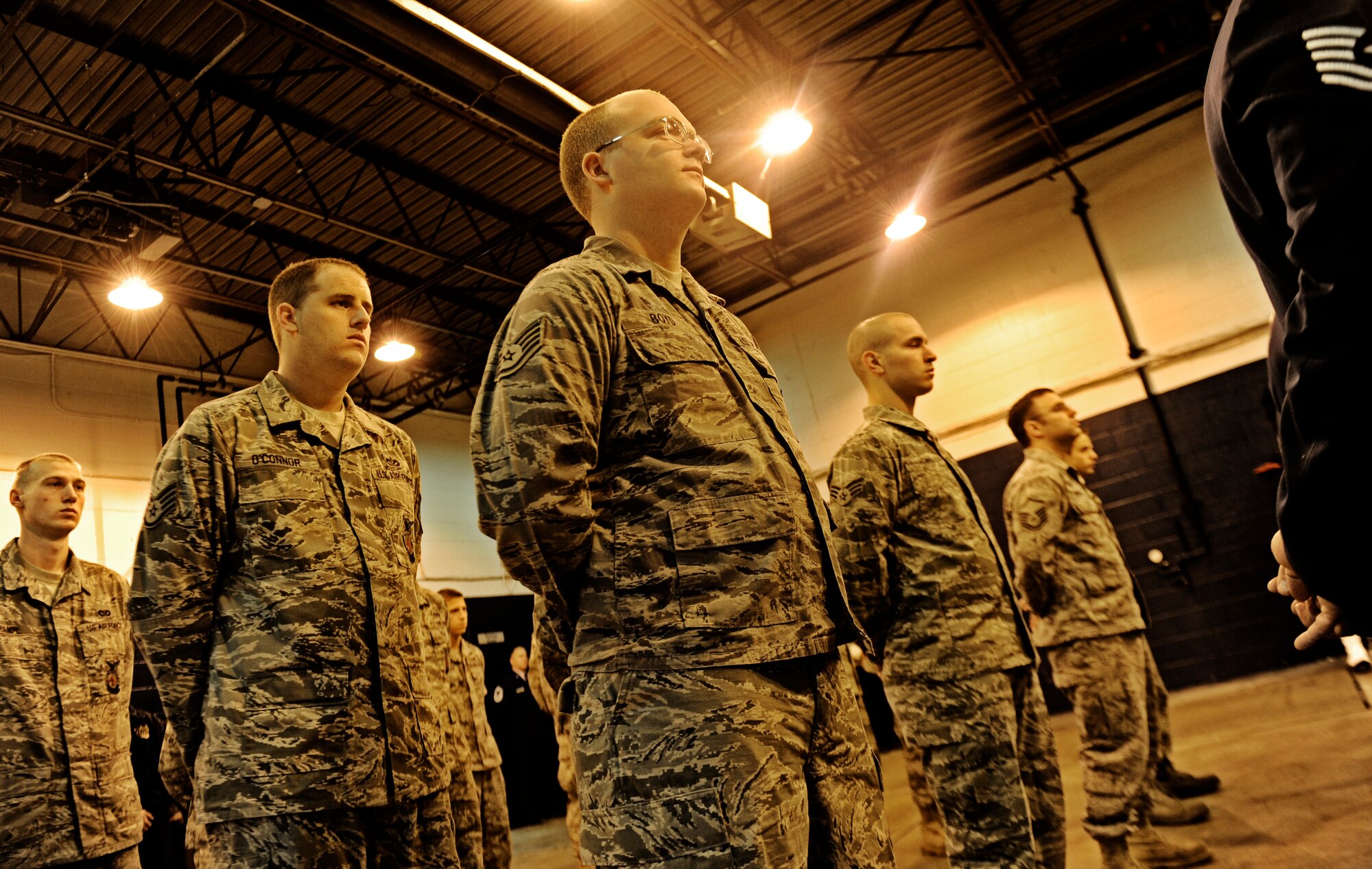 A flight of firefighters stands by as a few final words are said about Rick Grammer, Air Mobility Command fire chief, during a Final Alarm Ceremony Jan. 10, 2010 at Scott Air Force Base, Ill. Mr. Grammer passed away last week.  A Final Alarm Ceremony is a traditional final tribute to a firefighter who has passed.  The ceremony begins by calling the passed firefighter’s name and is followed by the ringing of the ceremonial fire bell.  Bagpipes are also commonly played.  The ceremony represents the firefighter’s final call to duty. (U.S. Air Force photo/ Staff Sgt. Ryan Crane)