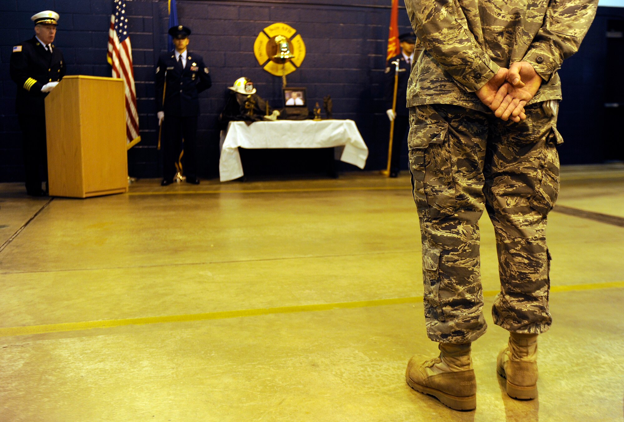 A flight of firefighters stands at parade rest while a few final words are said about Rick Grammer, Air Mobility Command fire chief, during a Final Alarm Ceremony, Jan. 10, 2010 at Scott Air Force Base, Ill. Mr. Grammer passed away last week.  A Final Alarm Ceremony is a traditional final tribute to a firefighter who has passed.  The ceremony begins by calling the passed firefighter’s name and is followed by the ringing of the ceremonial fire bell.  Bagpipes are also commonly played.  The ceremony represents the firefighter’s final call to duty. (U.S. Air Force photo/ Staff Sgt. Ryan Crane)