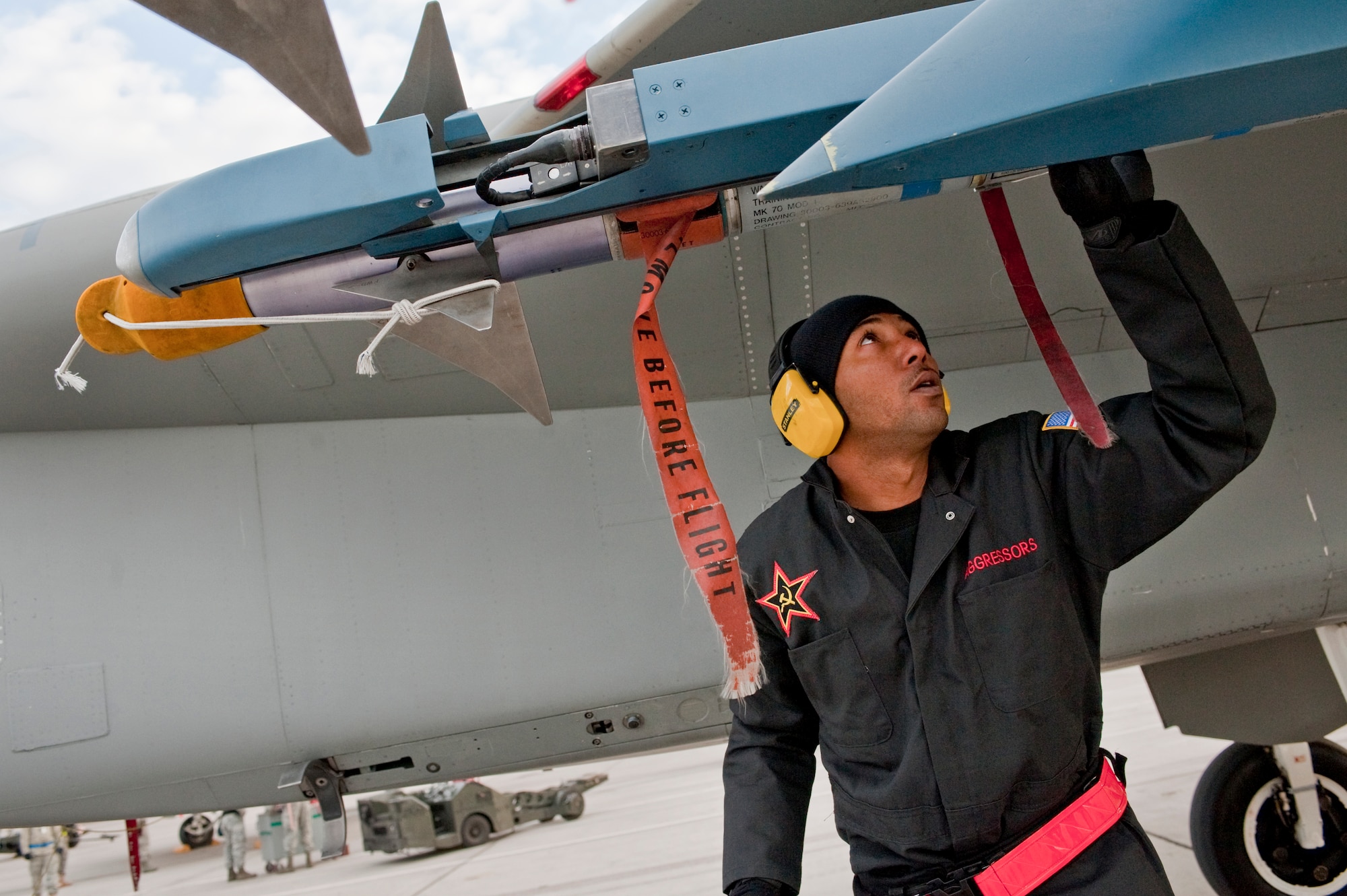 NELLIS AIR FORCE BASE, Nev. --  Staff Sgt. Eric Crawley, 757th Aircraft Maintenance Squadron aircraft armament systems craftsman, conducts a post load check on an AIM-9 air to air missile during a weapons load competition on the Nellis flightline Jan. 7.  Weapons load competitions are conducted quarterly to keep Airmen sharp and recognize superior performers. Weapons load teams are evaluated for use of the checklist, safety, and overall speed. (U.S. Air Force photo by Tech Sgt. Michael R. Holzworth)





