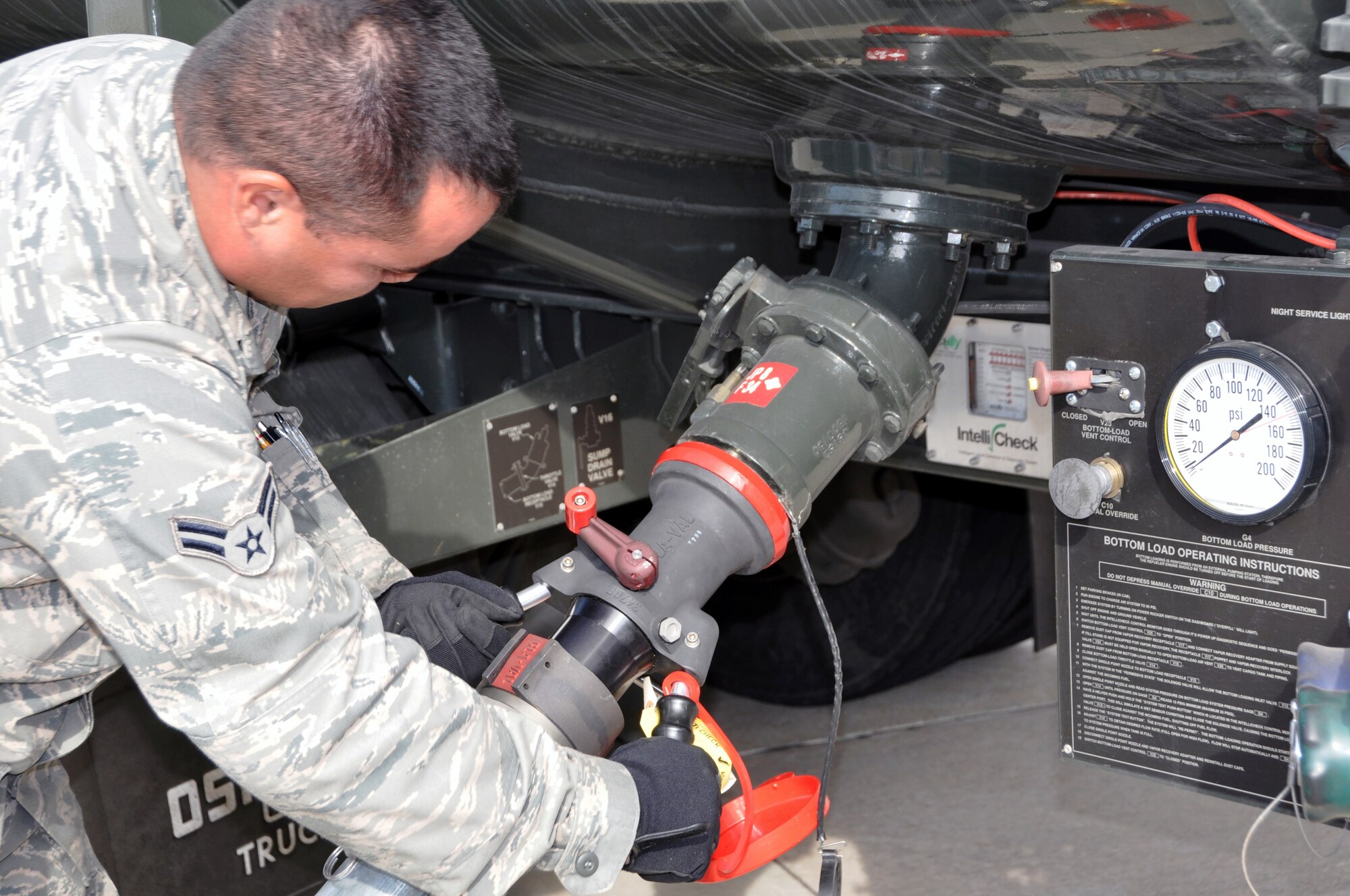 A1C Wesley Green, 301st Fuels Management Flight fuel technician, connects a hose to one of the fuel trucks that carry alternative fuel to F-16s during the field service evaluation. The evaluation began Monday, Jan. 10 and will continue until supplies are depleted. (U.S. Air Force photo/SrA Melissa Harvey)