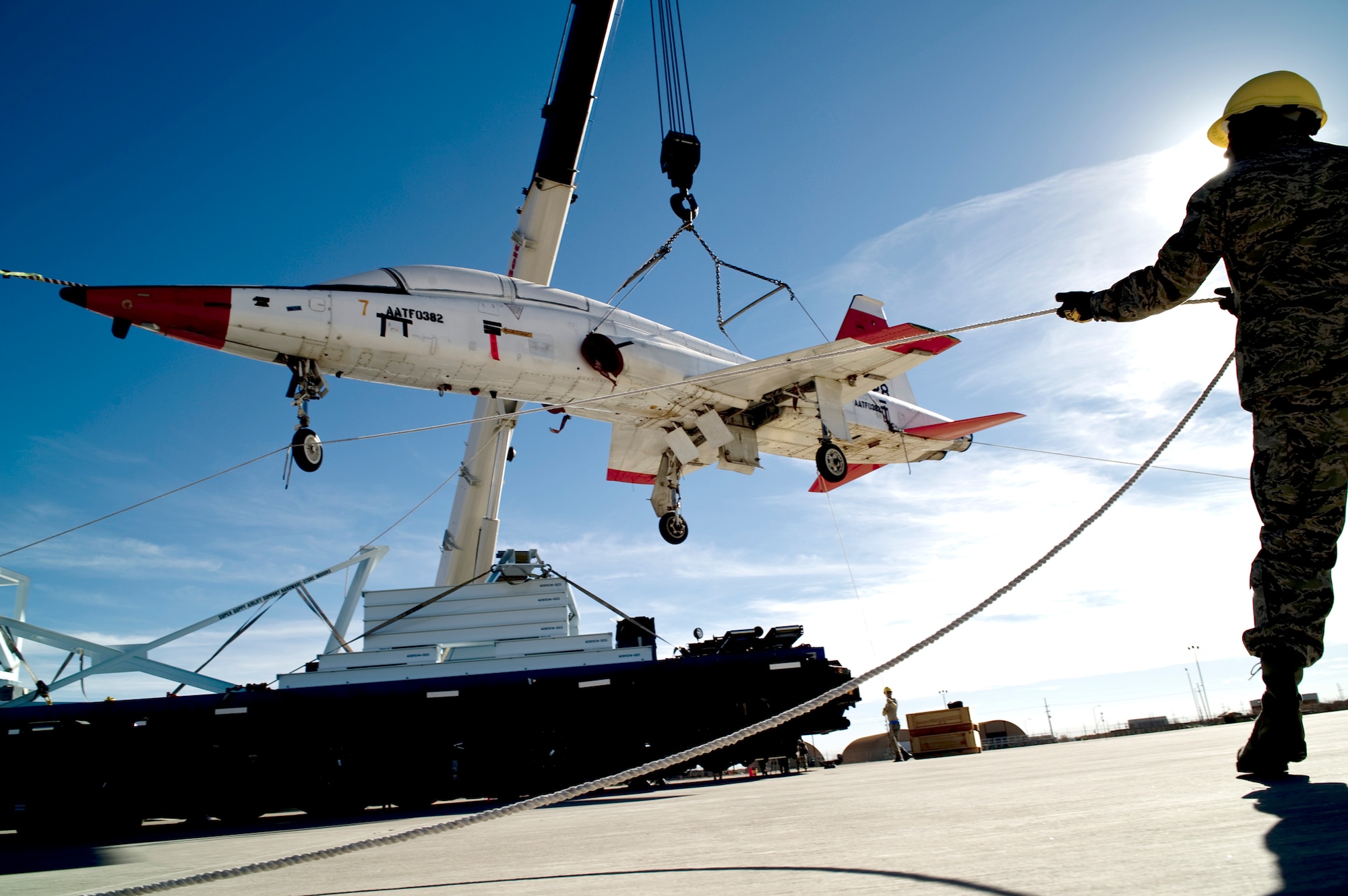 Staff Sgt. Edward Harris holds a tether line during the unloading of two T-38 Talons Dec. 14, 2010, at Holloman Air Force Base, N.M. The aircraft were transported here using NASA's Super Guppy aircraft and are the first two of 15 to be shipped here. The aircraft were used by South Korea for training and will now be regenerated and used as fifth generation fighter support. Holloman AFB officials will regenerate the T-38s before they are sent to Joint Base Langley-Eustis, Va. and Tyndall AFB, Fla. Sergeant Harris is assigned to the 49th Aircraft Maintenance Squadron. (U.S. Air Force photo/Airman 1st Class Joshua Turner)