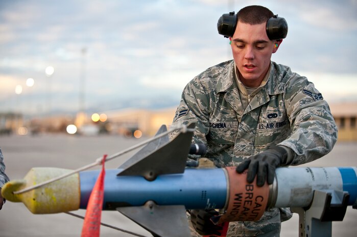 NELLIS AIR FORCE BASE, Nev. --  Airman 1st Class Michael Schena, 757th Aircraft Maintenance Squadron aircraft armament systems apprentice, conducts pre-load checks on an AIM-9 air to air missile during a  weapons load competition on the Nellis flightline Jan. 7. Weapons load competitions are conducted quarterly to keep Airmen sharp and recognize superior performers. Weapons load teams are evaluated for their use of the checklist, safety, and overall speed. (U.S. Air Force photo by Tech Sgt. Michael R. Holzworth)