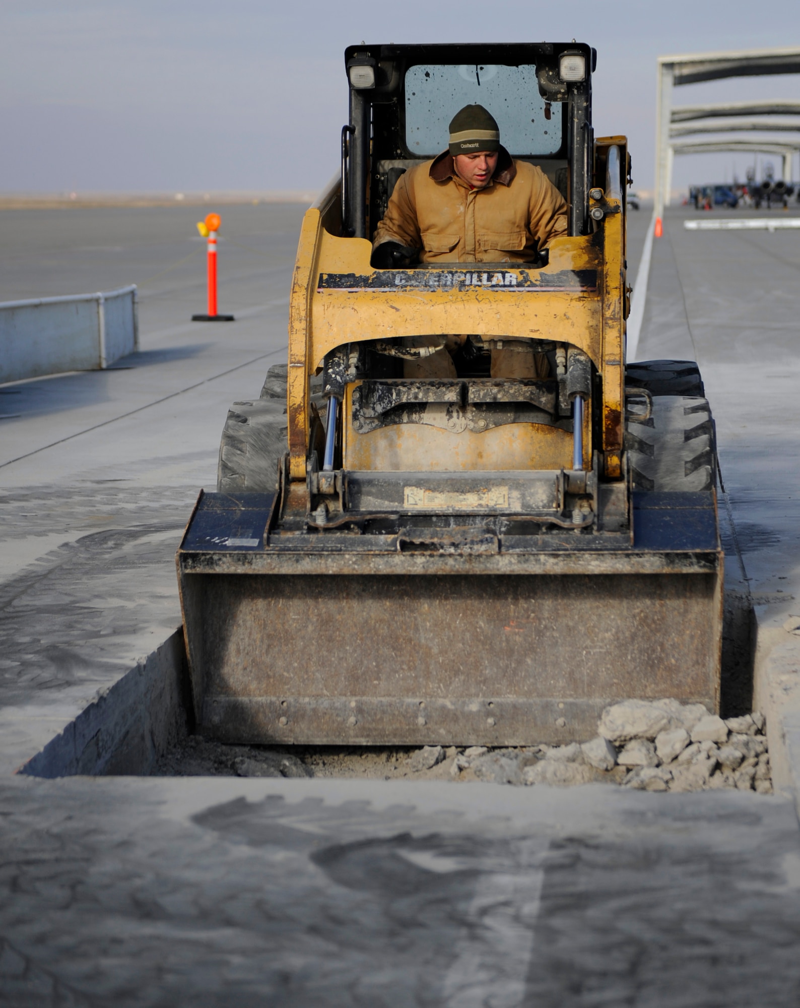 MOUNTAIN HOME AIR FORCE BASE, Idaho -- A contractor with EDL Construction, Inc. digs out concrete during the start of new aircraft shelters in front of the 389th Fighter Squadron Jan. 5. In May, a contract for more than $4.2 million was awarded to EDL Construction, Inc. to build the 54 aircraft shelters that provide cover for maintainers. (U.S. Air Force photo by Senior Airman Renishia Richardson)
