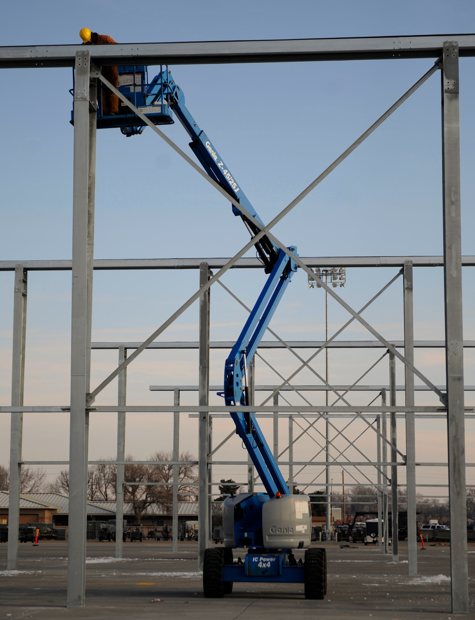 MOUNTAIN HOME AIR FORCE BASE, Idaho -- A contractor with EDL Construction, Inc. bolts down a steel beam during the building of new aircraft shelters in front of the 389th Fighter Squadron Jan. 5. In May, a contract for more than $4.2 million was awarded to EDL Construction, Inc. to build the 54 aircraft shelters that provide cover for maintainers. (U.S. Air Force photo by Senior Airman Renishia Richardson)