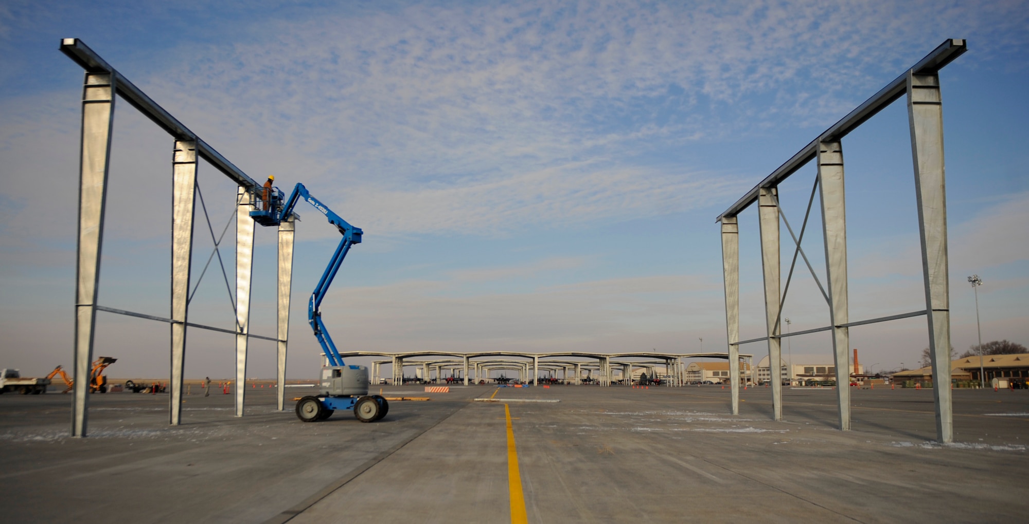 MOUNTAIN HOME AIR FORCE BASE, Idaho -- Contractors work to build new aircraft shelters on the flightline in front of the 389th Fighter Squadron Jan. 5. In May, a contract for more than $4.2 million was awarded to EDL Construction, Inc. to build the 54 aircraft shelters that provide cover for maintainers. (U.S. Air Force photo by Senior Airman Renishia Richardson)