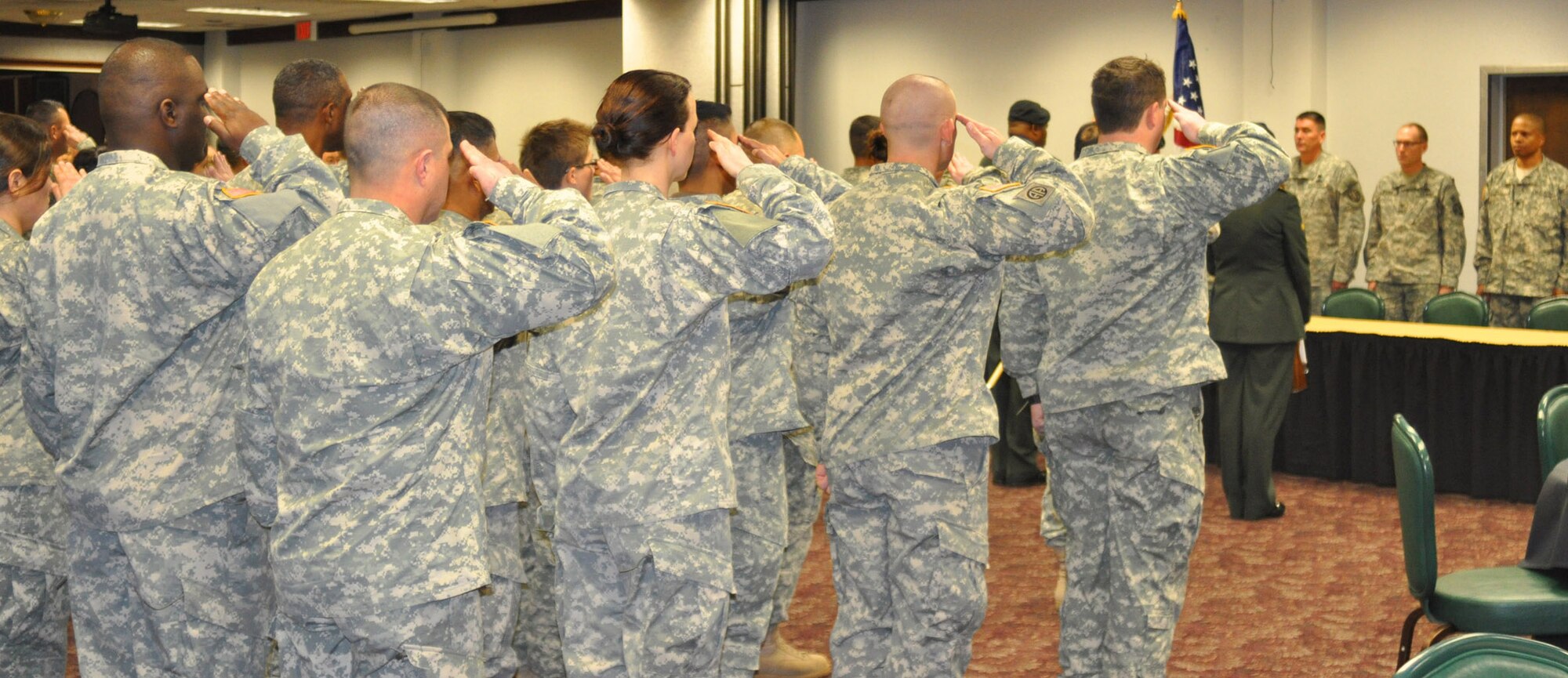 The Soldiers of the 7230th Medical Support Unit salute during the National Anthem at their deployment ceremony at the Hap Arnold Club Jan. 5, 2011, at March Air Reserve Base, Calif.  The southern California Army reservists, who are based at the Armed Forces Reserve Center adjacent to the base, will deploy for a year to support medical screenings for the Soldier Readiness Program at Joint Base Lewis-McChord, Wash.    (U.S. Air Force photo/Megan Just)