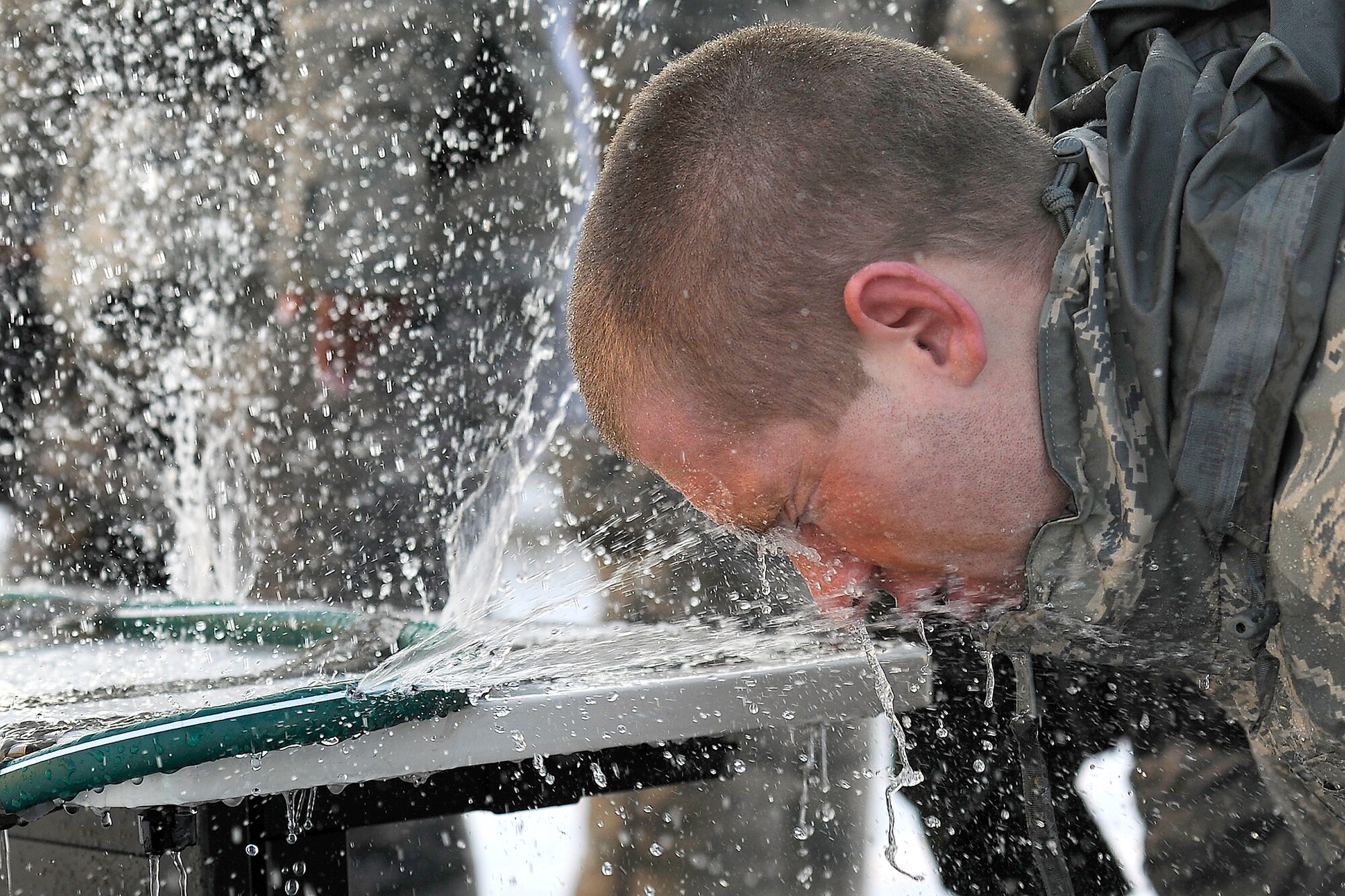Airman 1st Class Thomas Hearton washes off Oleoresin Capsicum spray from his face Jan. 5, 2011, at Hill Air Force Base, Utah. OC spray is a non-lethal spray, similar to pepper spray, used to temporarily incapacitate individuals. All security forces Airmen receive the OC training when they first arrive at their squadron. Airman Hearton is assigned to the 75th Security Forces Squadron. (U.S. Air Force photo/Staff Sgt. Tim Chacon)