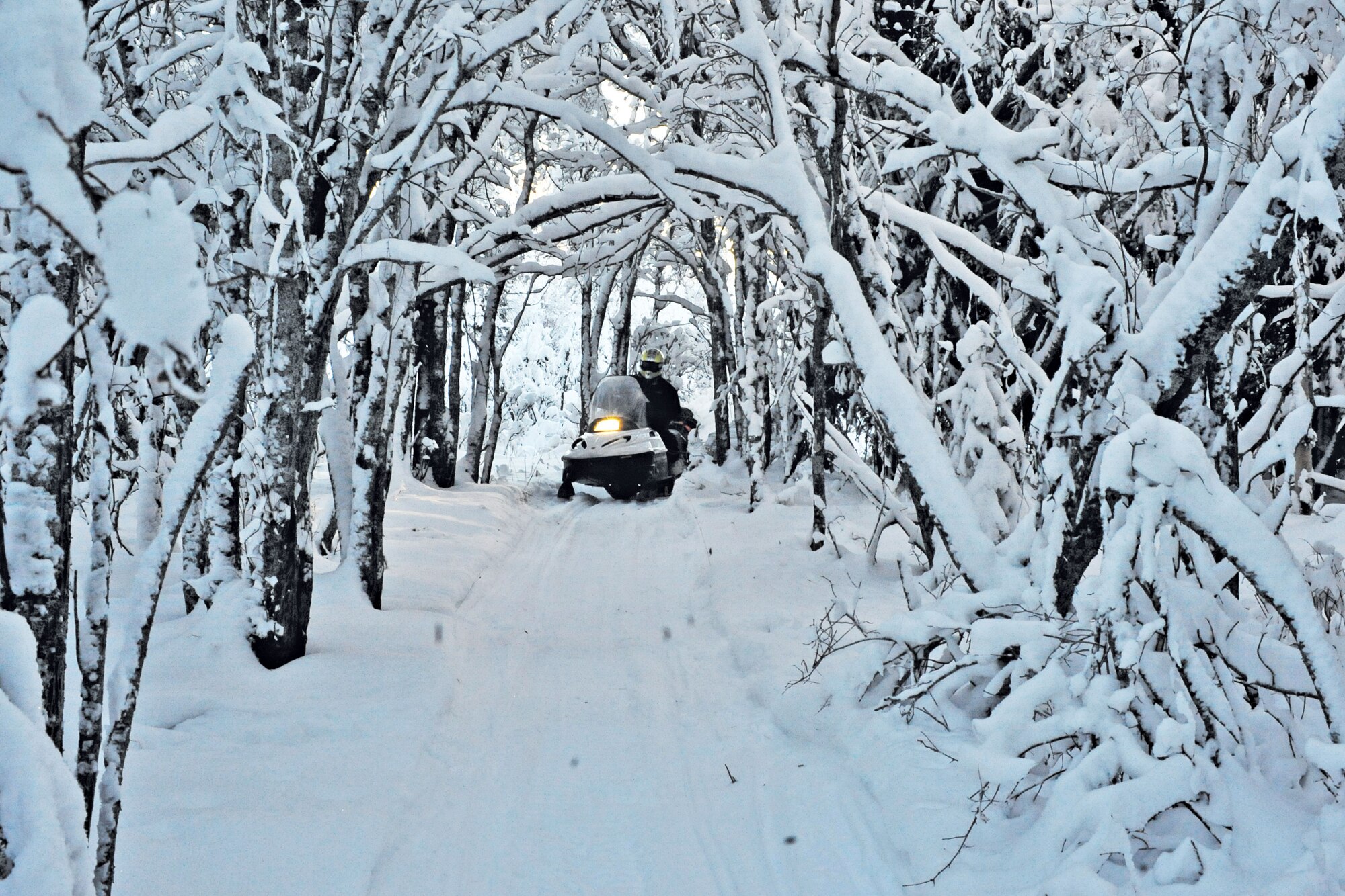 Toys for Tots remote delivery snow machine riders make their way through a snow covered pass delivering toys. Marines from Delta Company, Anit-terrorism Battalion, 4th Marine Division spend every December delivering toys to children in rural areas of Alaska.
