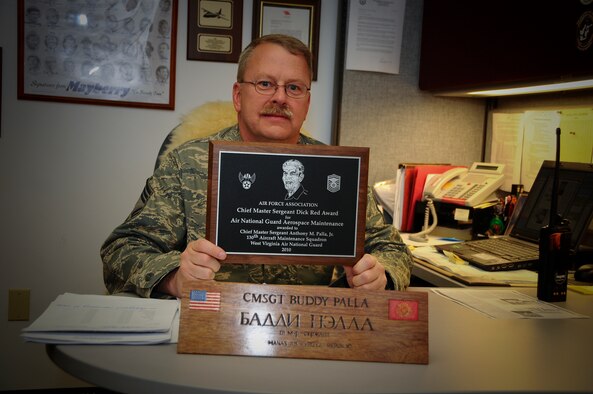 Chief Master Sgt. Buddy Palla, aircraft maintenance superintendent with the 130th Aircraft Maintenance Squadron, 130th Airlift Wing, West Virginia Air National Guard, Charleston, West Virginia, poses for a portrait in his office with the CMsgt. Dick Red Award, Nov. 7, 2010. The Air Force Association presented Chief Master Sgt. Palla with the award, Sept. 13, 2010, at its annual conference in the Washington, D.C. area. Chief Master Sgt. Palla is the 26th receipient of the award which is given each year to the top aircraft maintainer in the Air National Guard. (U.S. Air Force photo by Tech. Sgt. Brian G. Stevens)