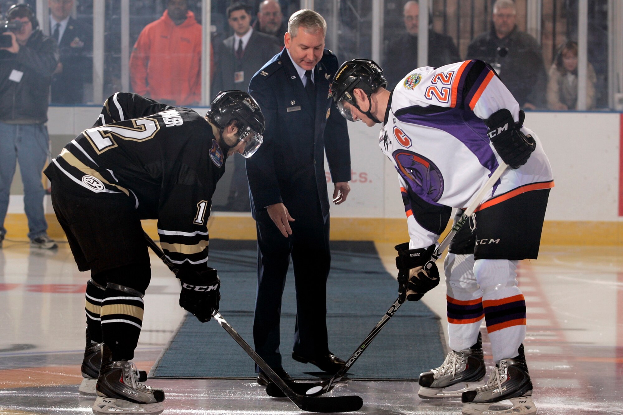YOUNGSTOWN, Ohio -- Air Force Reserve Col. Fritz Linsenmeyer, commander of the 910th Airlift Wing, drops the ceremonial puck during pre-game festivities for a Youngstown Phantoms hockey game at the Covelli Centre here, Jan. 8. Colonel Linsenmeyer and more than 130 Citizen Airmen based at nearby Youngstown Air Reserve Station, Ohio participated in Military Appreciation night activities before and during the game. The Phantoms, a member of the United States Hockey League, defeated the Muskegon Lumberjacks 4-3 in front of a crowd of more than 1600 people. Courtesy Photo by Justin K. Aller.  