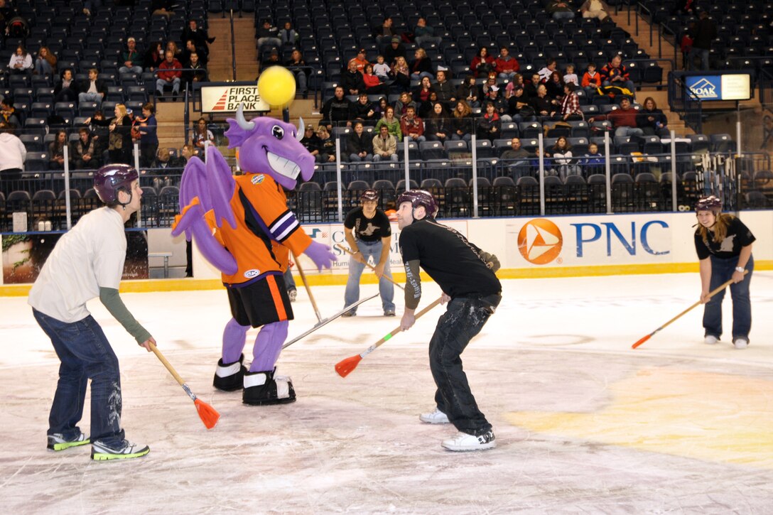 YOUNGSTOWN, Ohio -- Air Force Reserve DEPers, members of the 910th Recruiting Squadron's Delayed Enlisted Program, play a game of broomball during the first intermission of a Youngstown Phantoms hockey game at the Covelli Centre here, Jan. 8. The DEPers and more than 130 Citizen Airmen based at nearby Youngstown Air Reserve Station, Ohio participated in Military Appreciation night activities before and during the game. The Phantoms, a member of the United States Hockey League, defeated the Muskegon Lumberjacks 4-3 in front of a crowd of more than 1600 people. U.S. Air Force photo by Master Sgt. Bob Barko Jr.  