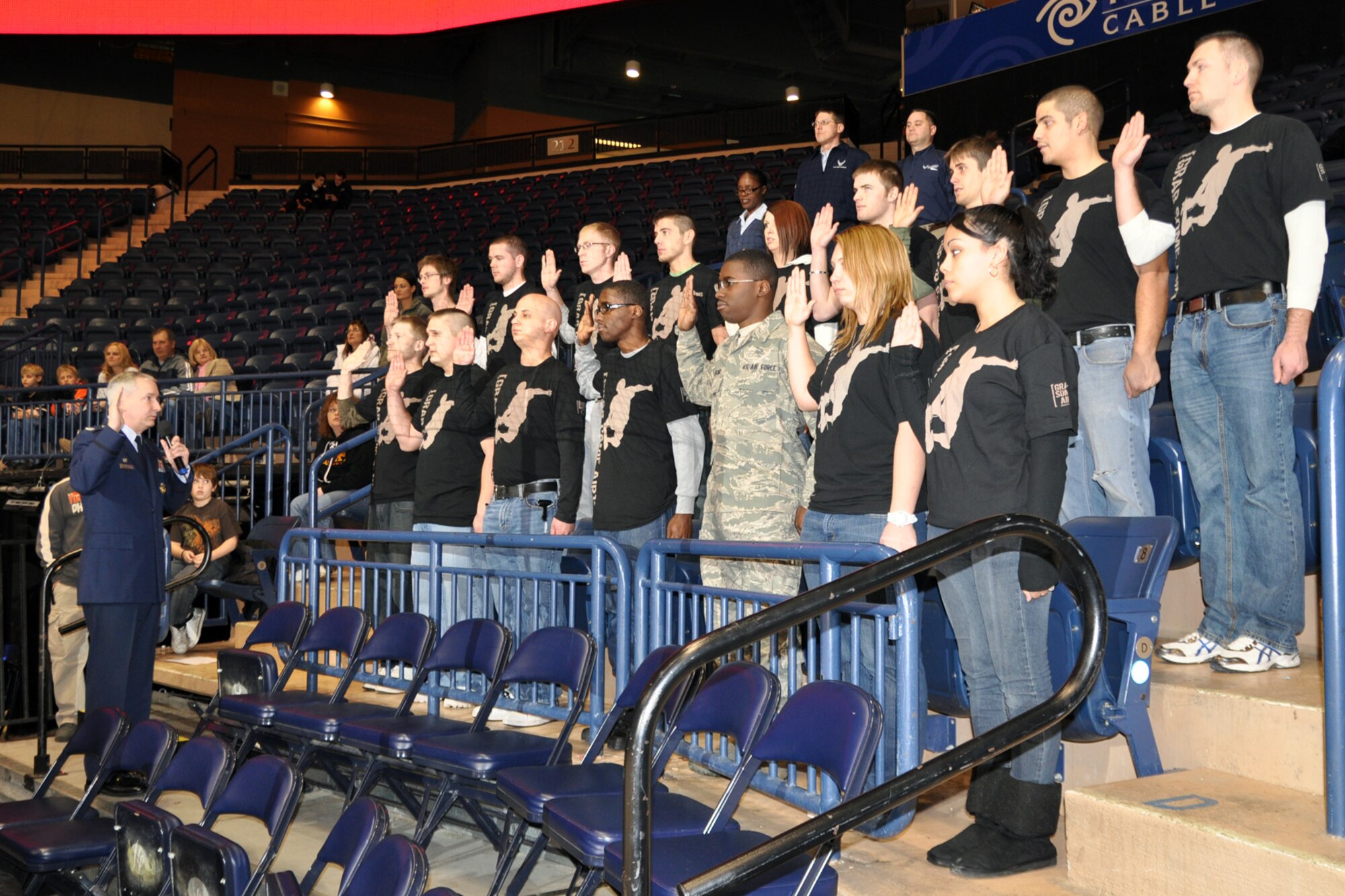 YOUNGSTOWN, Ohio -- Air Force Reserve Col. Fritz Linsenmeyer, commander of the 910th Airlift Wing, gives the oath of enlistment to a group of recruits during a Youngstown Phantoms hockey game at the Covelli Centre here, Jan. 8. Colonel Linsenmeyer and more than 130 Citizen Airmen based at nearby Youngstown Air Reserve Station, Ohio participated in Military Appreciation night activities before and during the game. The Phantoms, a member of the United States Hockey League, defeated the Muskegon Lumberjacks 4-3 in front of a crowd of more than 1600 people. U.S. Air Force photo by Master Sgt. Bob Barko Jr.