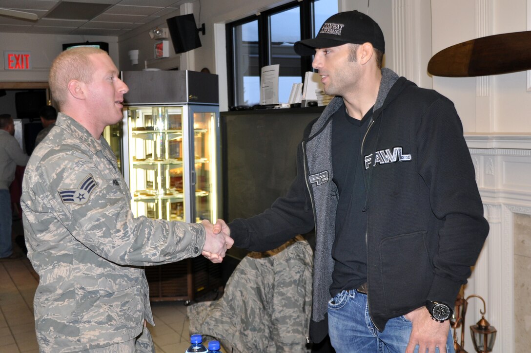 YOUNGSTOWN AIR RESERVE STATION, Ohio -- Air Force Reserve Senior Airman Jospeh Holmes, a diet technician assigned to the 910th Medical Squadron, shakes hands with UFC fighter Mike "Quick" Swick at the Eagle's Nest Club here, Jan. 8. The UFC fighter also attended the Youngstown Phantoms hockey game at the Covelli Centre in downtown Youngstown later that evening as part of Military Appreciation Night activities. He met game attendees for autographs and fan photo opportunities in the centre concourse at the Air Force Reserve display prior to the game. Swick, one of the world?s premier welterweight Mixed Martial Arts fighters, is visiting the Mahoning Valley in support of the 910th Air Force Reserve Recruiting's Get One Now Unit Member Referral program. The 910th has finished in the top two units for the past four years and a 910th unit member was the national award winner three years ago. for more information about the Get One Now program, visit www.get1now.us. U.S. Air Force photo by Master Sgt. Bob Barko Jr. 