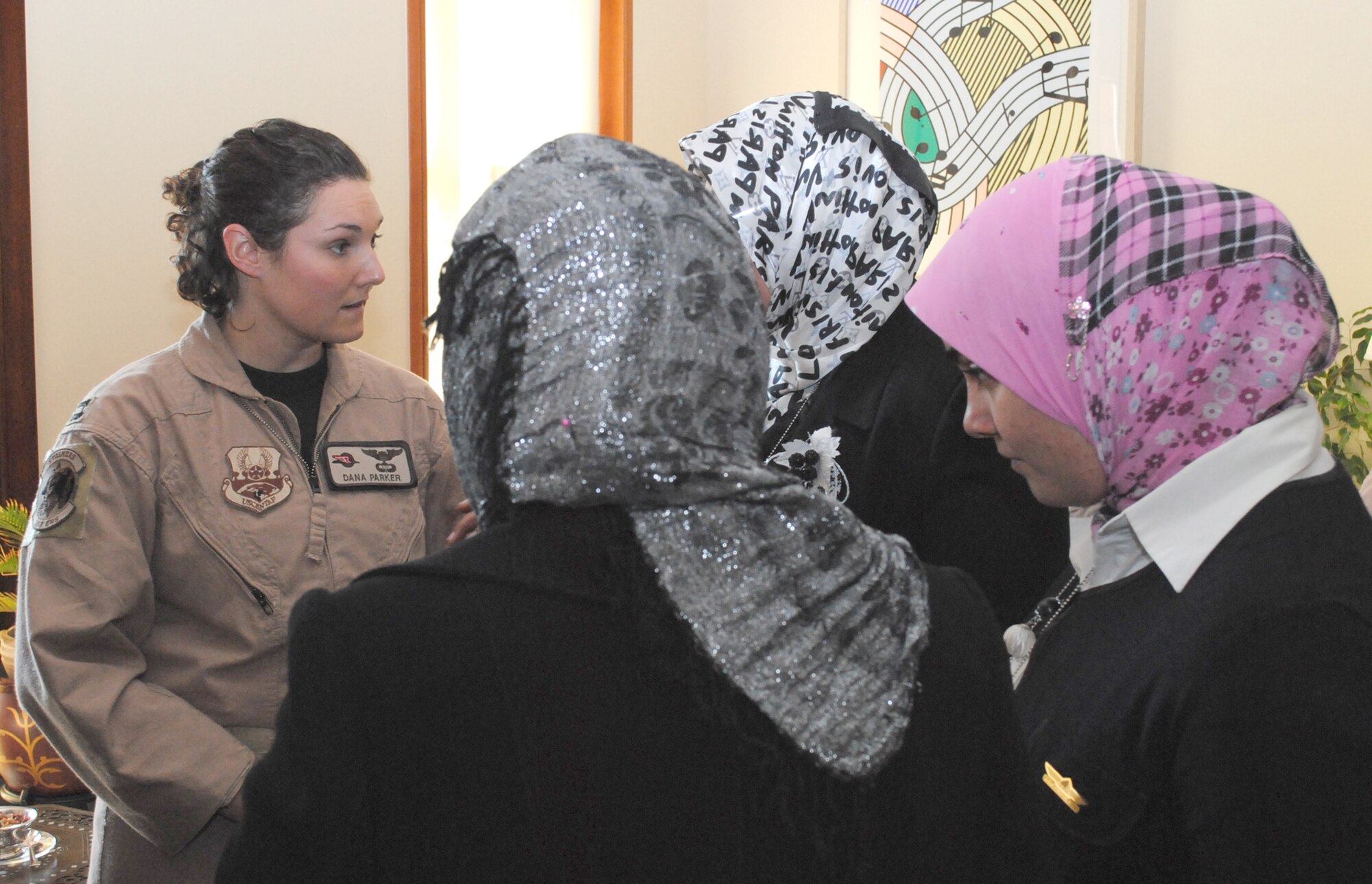 Capt. Dana Parker talks to several Iraqi women about her experiences in aviation during a luncheon for the Horizon East Women in Aviation, International chapter at the U.S. Embassy Jan. 7, 2011, in Baghdad. The Women in Aviation, International was established to encourage women to seek opportunities in aviation career fields and interests. Captain Parker is a C-130 Hercules and MC12 pilot from the 362nd Expeditionary Reconnaissance Squadron. (U.S. Army photo/Spc. Amie J. McMillan)