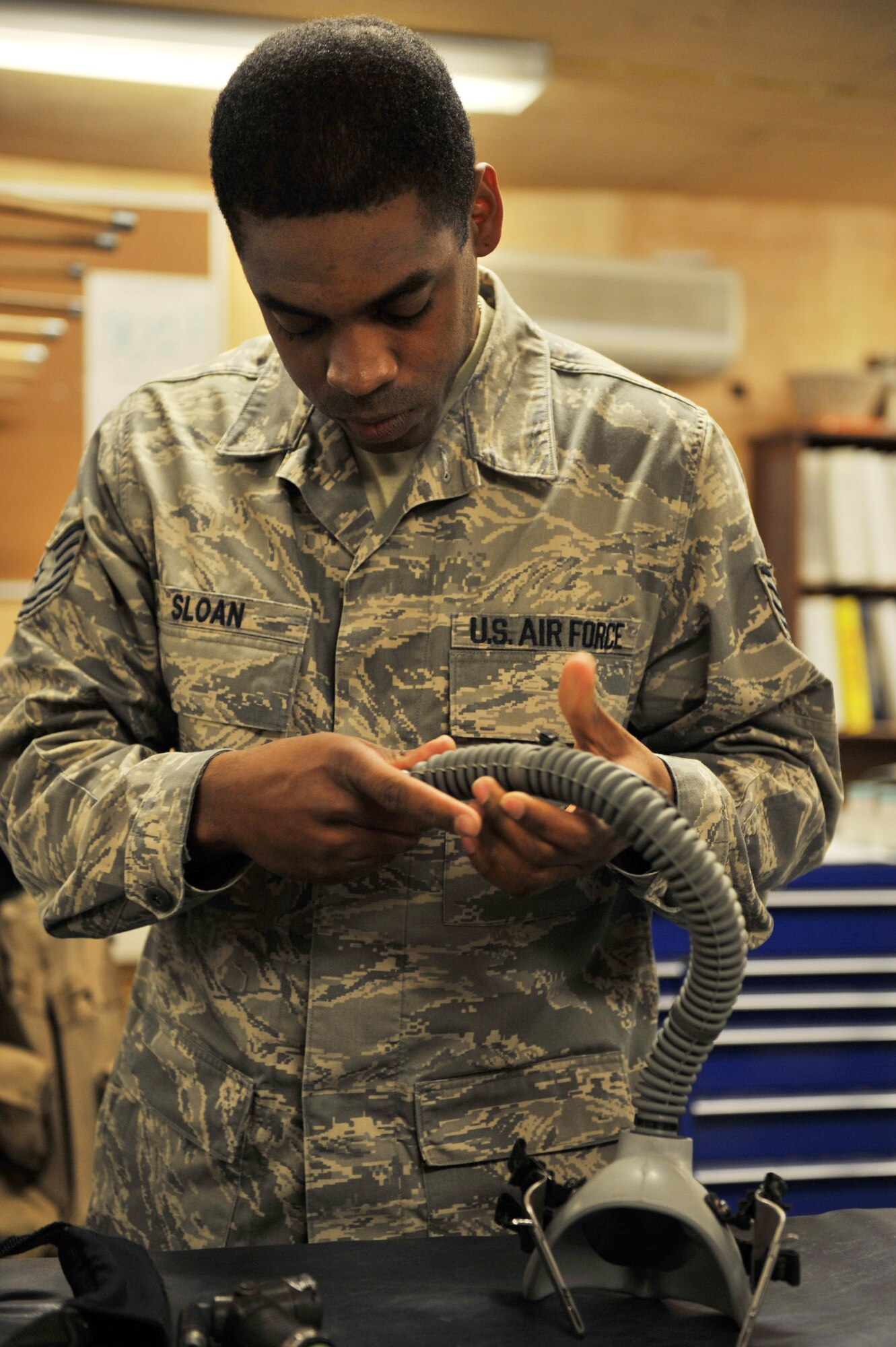 744th Expeditionary Airlift Squadron life support technician, Tech. Sgt. Jonathan Sloan inspects the CRU-60/P Oxygen Mask connector during a 30-day inspection at Bagram Airfield, Afghanistan, Jan. 10, 2011. Sergeant Sloan conducts a 30-day inspection on all aircrew flight equipment to ensure proper function. Sergeant Sloan is deployed from the 165th Airlift Wing in Savannah, Ga. (Air Force photo/Senior Airman Sheila deVera)