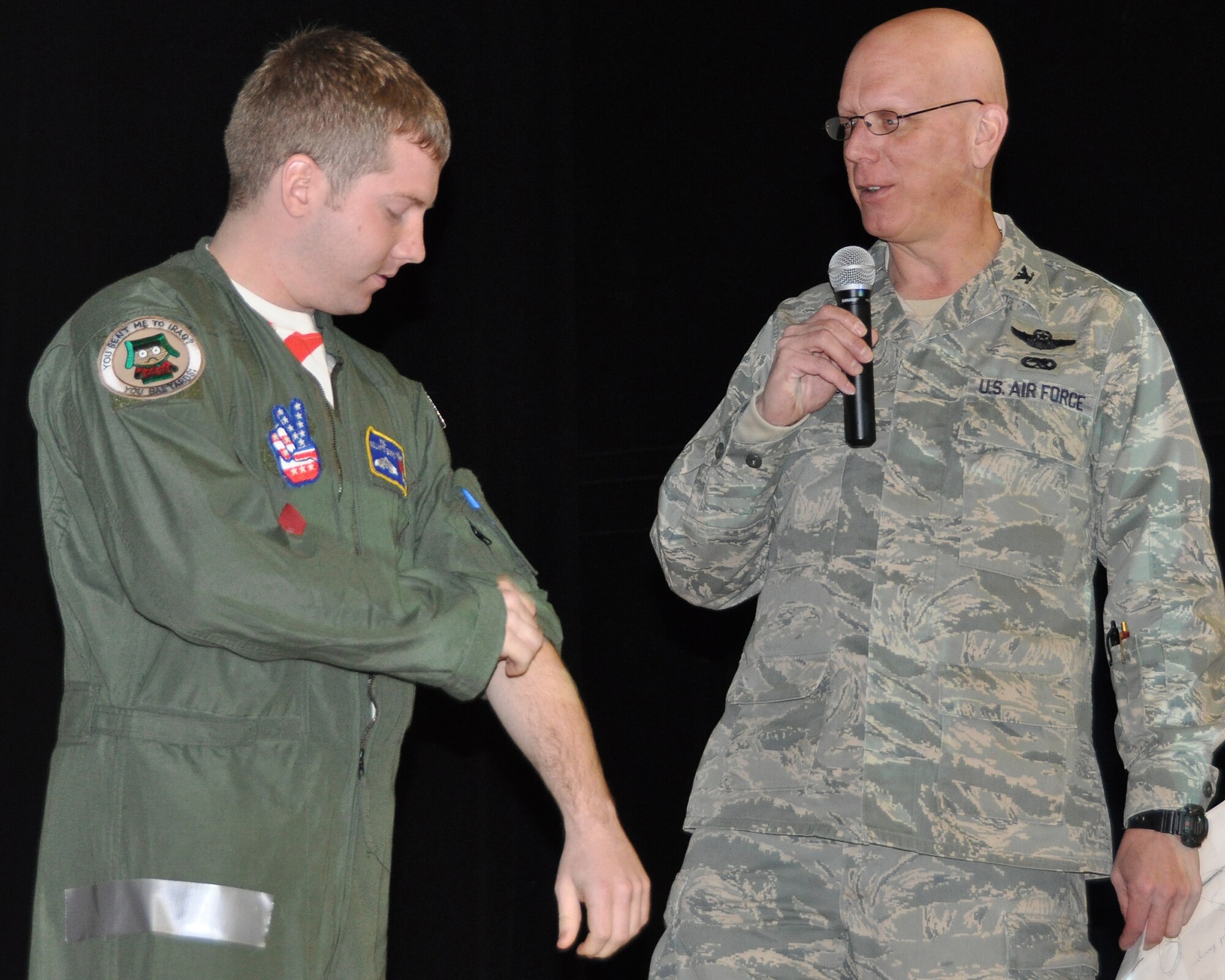 JOINT BASE MCGUIRE-DIX-LAKEHURST, NJ ? Senior Airman Shane Clayton (left), 732nd Airlift Squadron, demonstrates several common uniform-wear violations as part of a presentation by Col. Michael Underkofler, 514th Air Mobility Wing vice commander. During the presentation, Colonel Underkofler discussed the importance of wearing uniforms according to regulations and the need to point out uniform mistakes of fellow Airmen. (U.S. Air Force photo/Tech. Sgt. Shawn J. Jones)