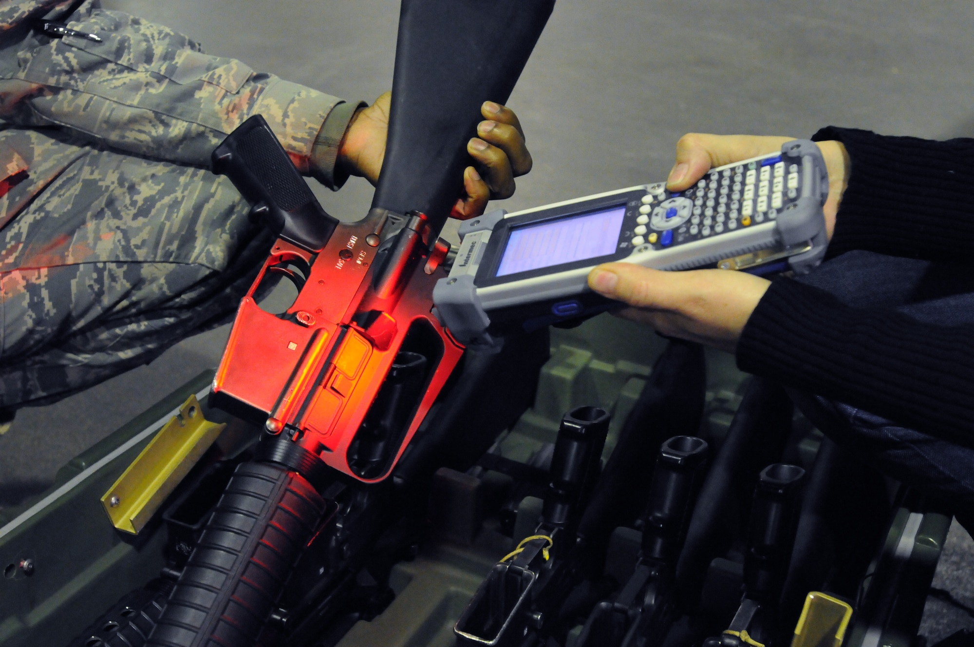 Equipment marking technicians scan a barcode on a weapon for inventory Dec. 17 as part of the new, revolutionary asset marking and tracking system being implemented at Air Force installations around the world. Each piece of equipment is being marked with a unique bar code that, when scanned, will provide the serial number and equipment information, including what the piece of equipment is, what base it belongs to and who it has been signed out to. (U.S. Air Force photo by Tech. Sgt. Darrell Dean)