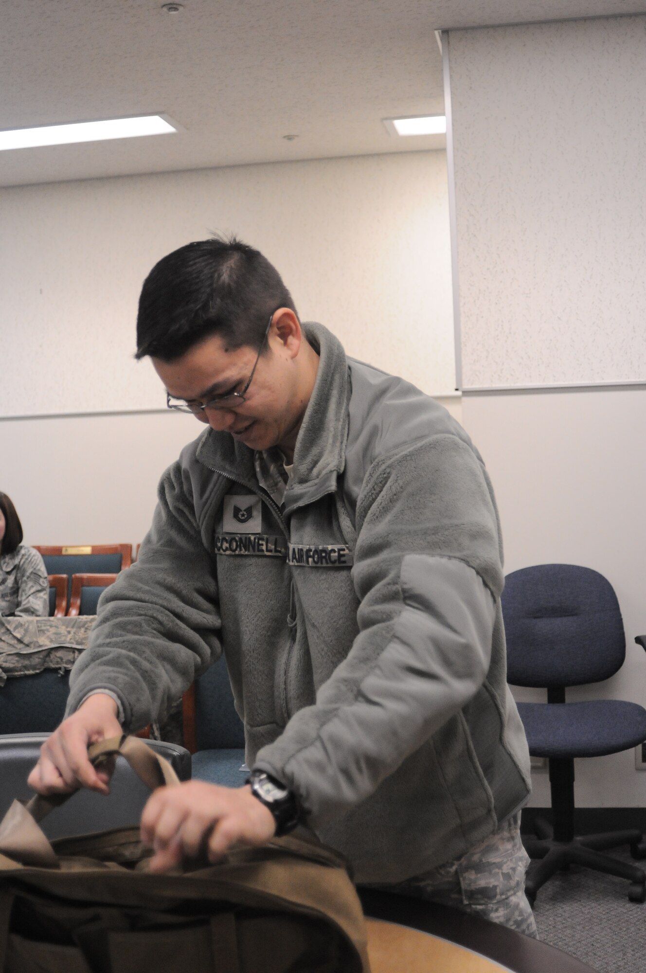 YOKOTA AIR BASE, Japan -- Tech Sgt. John McConnell, 374th Wing Staff Agency NCO in charge of client systems, searches through a medical bag for equipment to seal a sucking chest wound, here Jan. 07, during the Samurai Readiness Training Day. (U.S. Air Force photo/ Airman 1st Class Katrina R. Menchaca)