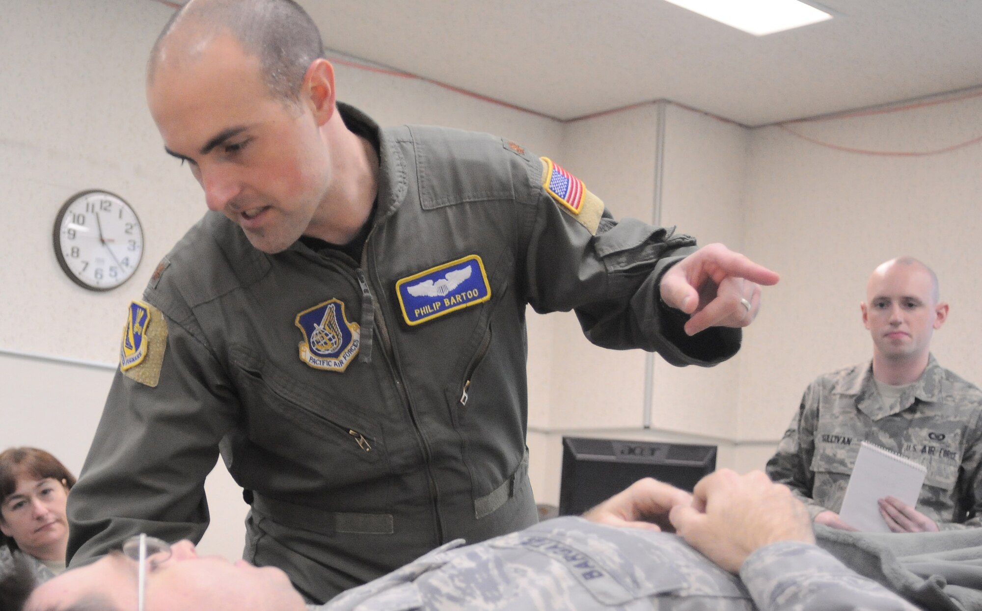 YOKOTA AIR BASE, Japan -- Major Philip Bartoo, 374th Airlift Wing Plans and Programs, practices Self-Aid and Buddy Care on Major David Bargate, 374th AW deputy staff judge advocate, here Jan. 07 during the Samurai Readiness Training Day. (U.S. Air Force photo/ Airman 1st Class Katrina R. Menchaca)