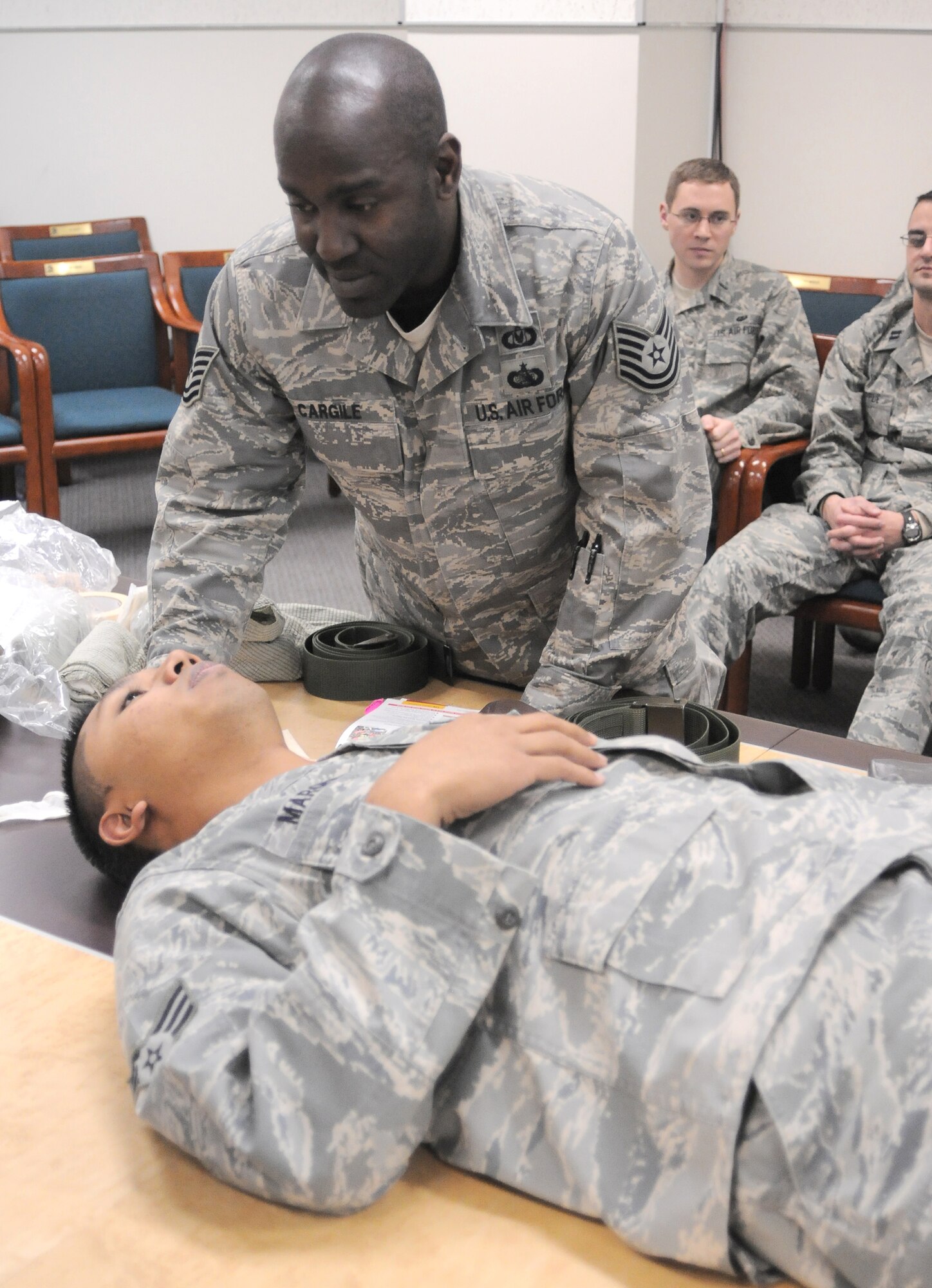 YOKOTA AIR BASE, Japan -- Tech. Sgt. Galen Cargile, 374th Airlift Wing safety, practices Self-Aid and Buddy Care on Senior Airman Mario Marquez, 374th Wing Staff Agency client system technician, here Jan. 07, during the Samurai Readiness Training Day. (U.S. Air Force photo/ Airman 1st Class Katrina R. Menchaca)