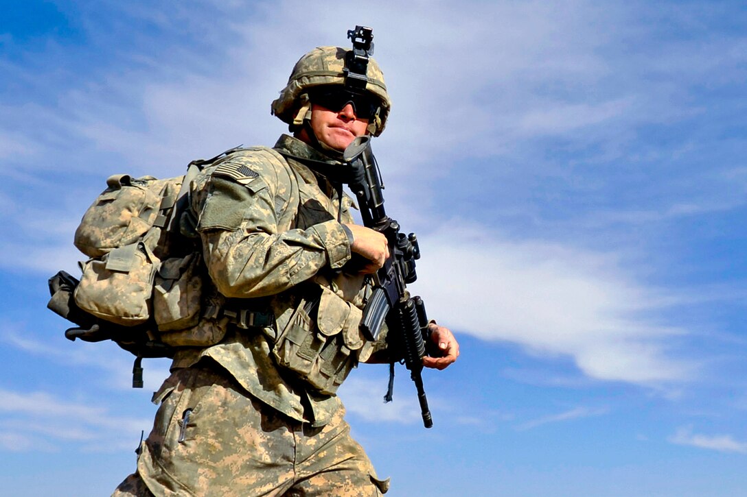 U.S. Army soldier walk across a field during a joint patrol with Afghan forces in the Andar district, Afghanistan, Jan. 07, 2011. The soldier is assigned to the 101st Airborne Division's Company C, 3rd Battalion, 187th Infantry Regiment.