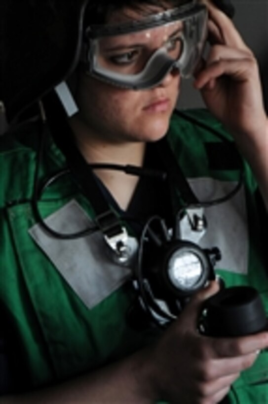 Seaman Autumn Hicks, from Denison, Texas, performs the duties of the fuel station phone talker during a replenishment at sea aboard the aircraft carrier USS Ronald Reagan (CVN 76) underway in the Pacific Ocean on Jan. 7, 2011.  The Ronald Reagan is preparing for an upcoming deployment.  
